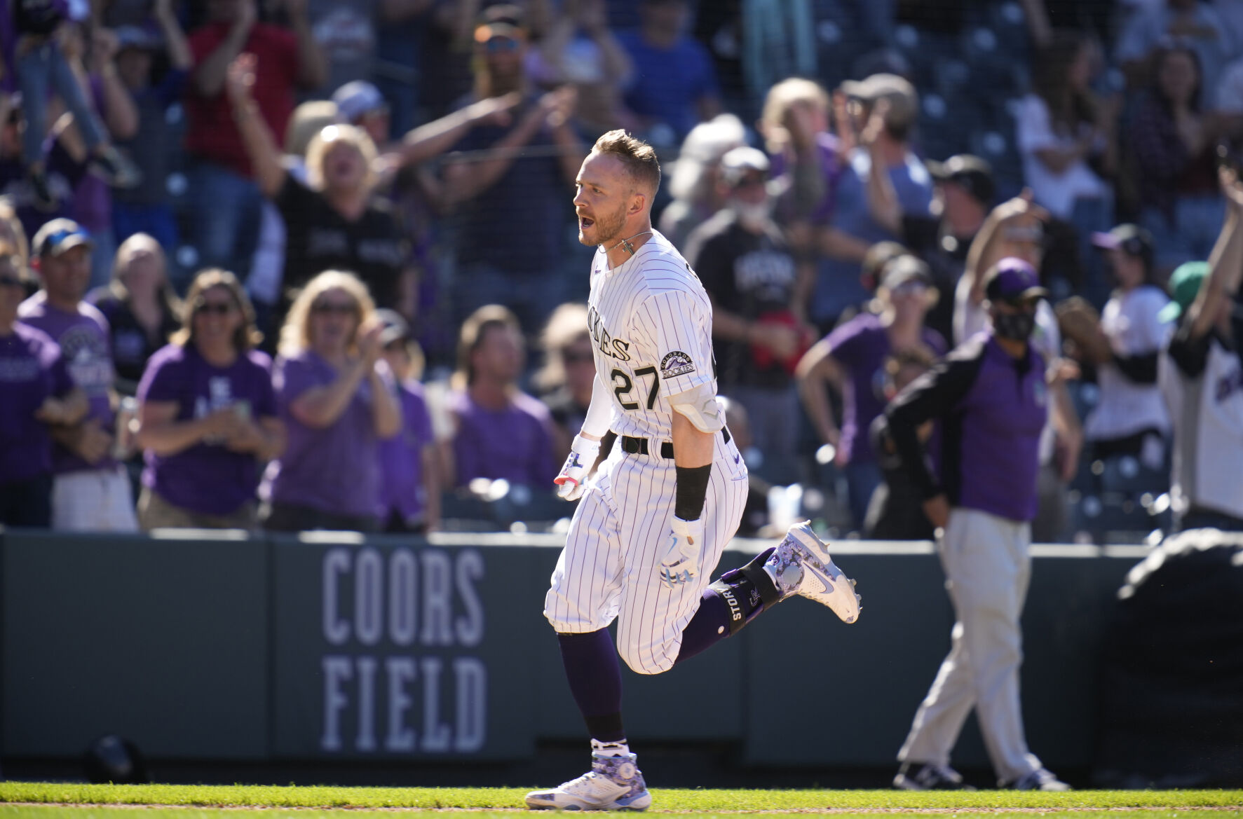 Fans cheer as Colorado Rockies Trevor Story, front, circles the bases after hitting a walk-off, solo home run off Arizona Diamondbacks relief pitcher Stefan Crichton in the ninth inning of a baseball game Sunday, May 23, 2021, in Denver. The Rockies won 4-3. (AP Photo/David Zalubowski) (David Zalubowski)
