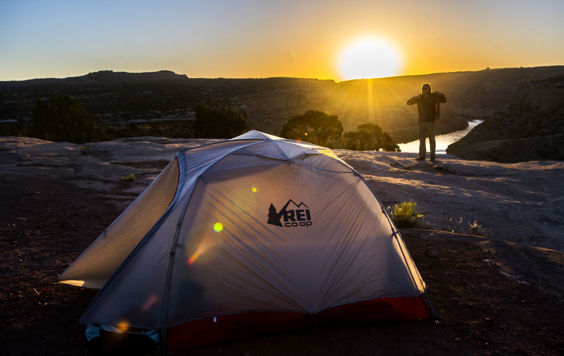 Reporter Seth Boster puts on another layer of clothes after waking up on cliffs above the Colorado River in the Knowles Canyon Overlook Campground in June 2018. The campground was otherwise empty — a rarity these days amid Colorado’s increasingly crowded outdoors scene. (Christian Murdock, the gazette)