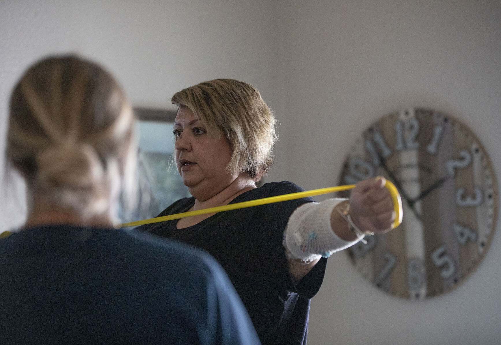 Kendra Lippy, 38, works on upper body strengthening exercises with the direction of Nicole Apsey, occupational therapist with 24/7 Healthcare, at her home in Colorado Springs on May 14, 2020. After receiving the Johnson & Johnson COVID-19 vaccine this spring, Lippy suffered severe side-effects and almost died. Lippy developed blood clots that destroyed her small intestine and caused her organs to start failing. She spent 33 days in the hospital as her doctors tried to determine the source of the problem. She was in an induced coma for 22 days with feeding tubes. Doctors removed most of her small intestine, leaving only 90 centimeters. (Chancey Bush/ The Gazette) (Chancey Bush/ The Gazette)