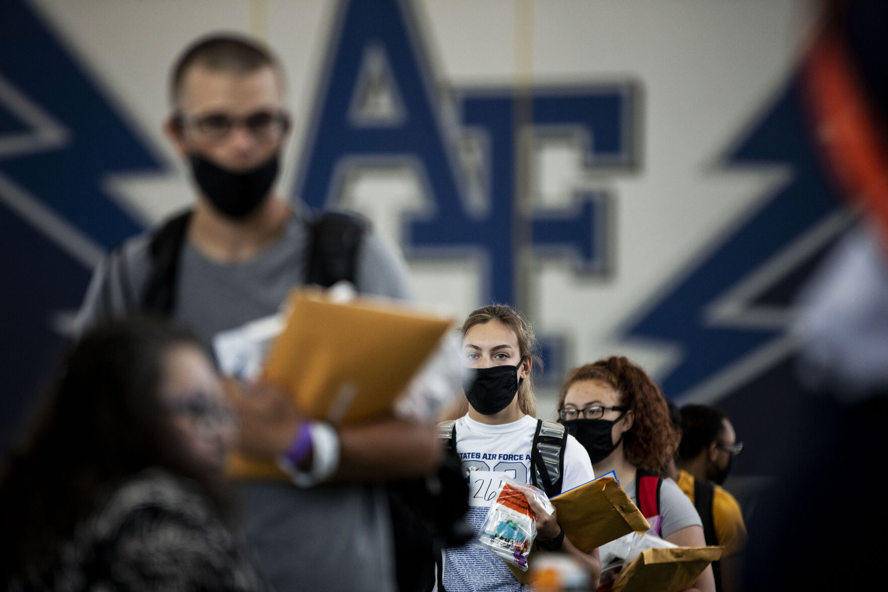 Basic cadet Avery Kreischer, 18, from Juneau, Alaska, waits in line at the Holaday Athletic Center during In-Processing Day at the United States Air Force Academy in Colorado Springs, Colo., on Thursday, June 24, 2021. Over 1,100 incoming freshman will undergo six weeks of basic training before officially becoming cadets.(Chancey Bush/ The Gazette) (Chancey Bush/ The Gazette)