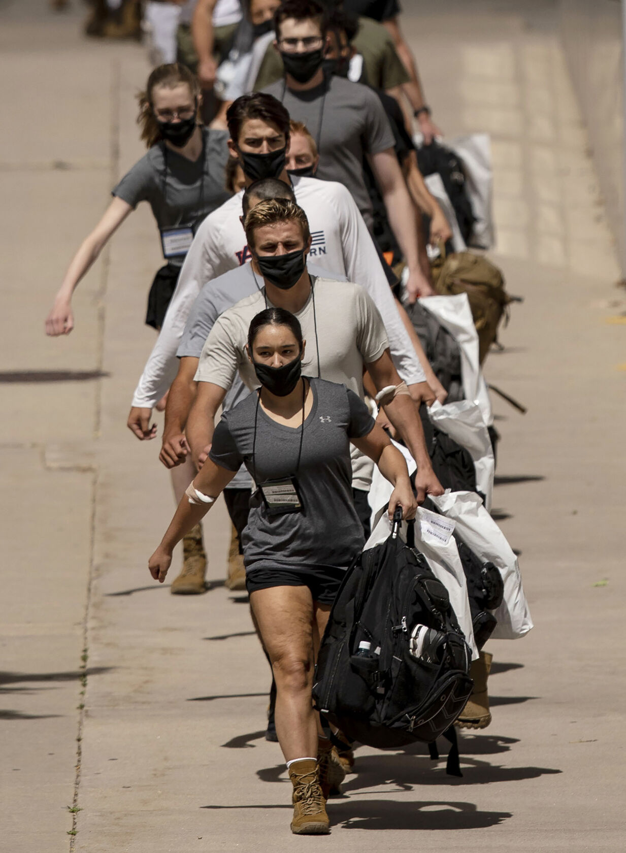 Basic cadets march in a line to load onto a bus during In-Processing Day at the United States Air Force Academy in Colorado Springs, Colo., on Thursday, June 24, 2021. Over 1,100 incoming freshman will undergo six weeks of basic training before officially becoming cadets.(Chancey Bush/ The Gazette) (Chancey Bush/ The Gazette)