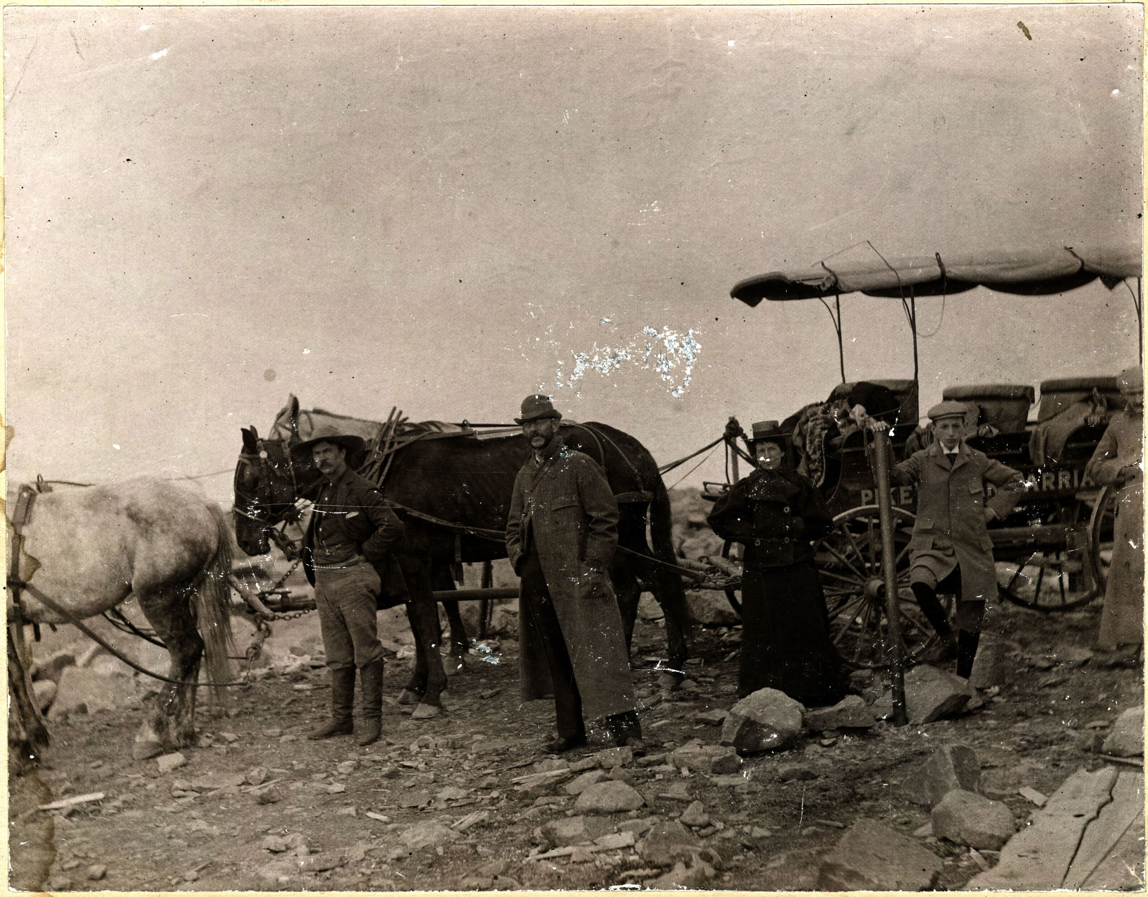 Three men and a woman stand in front of a carriage on Pikes Peak in this undated photograph. The Pikes Peak Carriage Road, which opened in 1887, was used to take passengers to the summit of Pikes Peak. Now travelers can take the Pikes Peak Highway to the top of America’s Mountain.