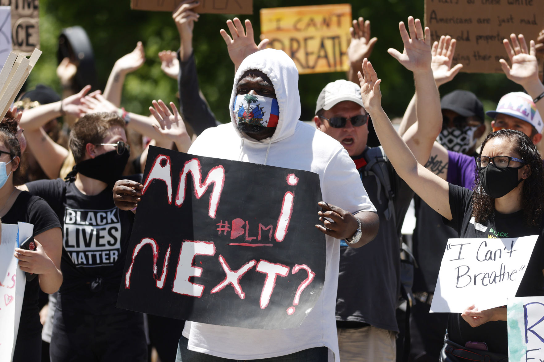 FILE PHOTO: A participant holds a placard on May 31, 2020, during a protest outside the state Capitol in Denver over the death of George Floyd six days earlier. (ASSOCIATED PRESS)