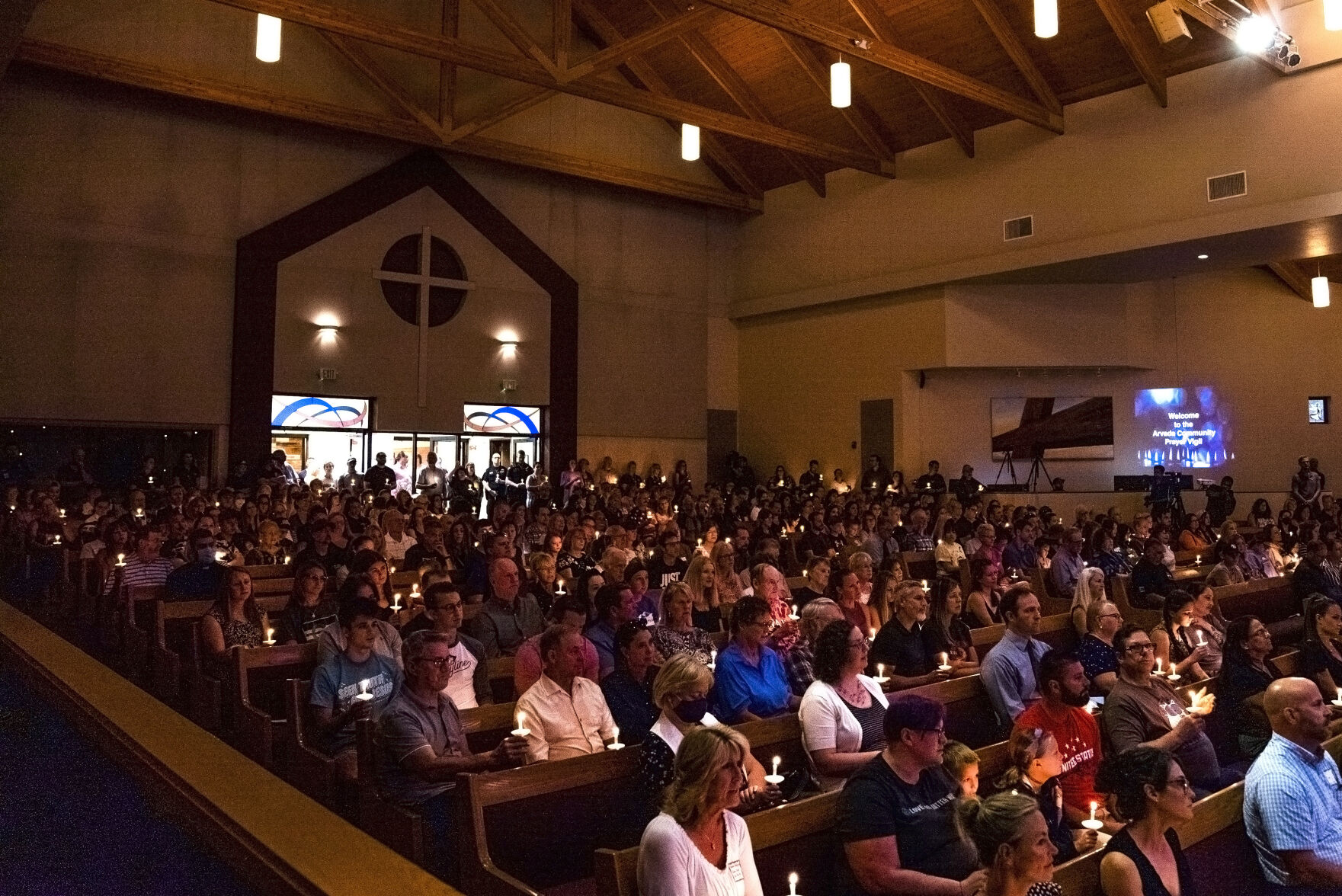 Community members sing ‘Amazing Grace’ as they light candles during a community vigil for fallen Officer Gordon Beesley on Tuesday, June 22, 2021 at Peace Lutheran Church in Arvada, Colo. (Katie Klann/The Denver Gazette) (Katie Klann The Gazette)