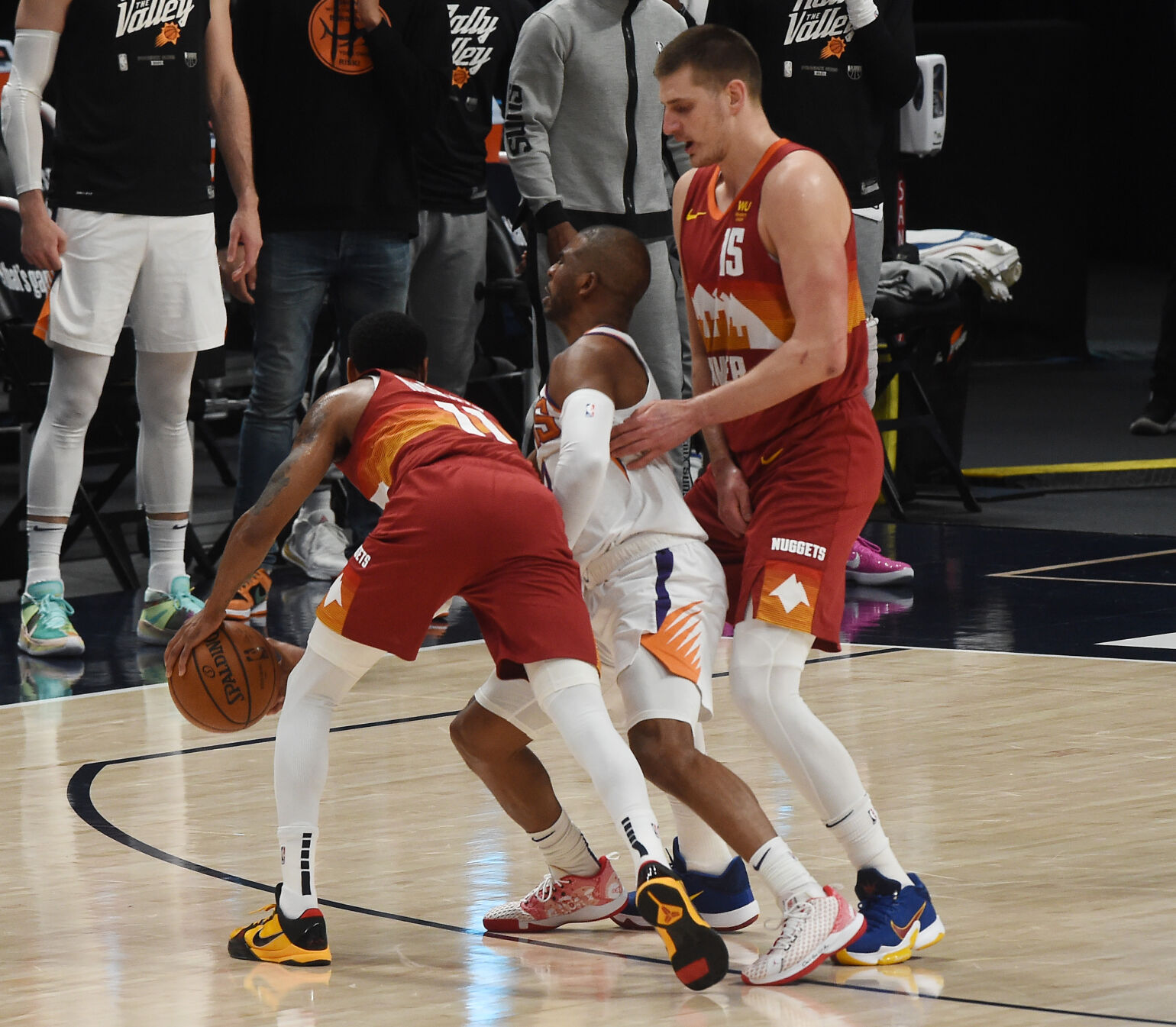 Denver’s Monte Morris and Nikola Jokic sandwich Chris Paul before Morris scores 2 during the first quarter of game 4 of the conference semifinals at Ball Arena on Sunday, June 13, 2021. (Photo by Jerilee Bennett, The Gazette) (JERILEE BENNETT)