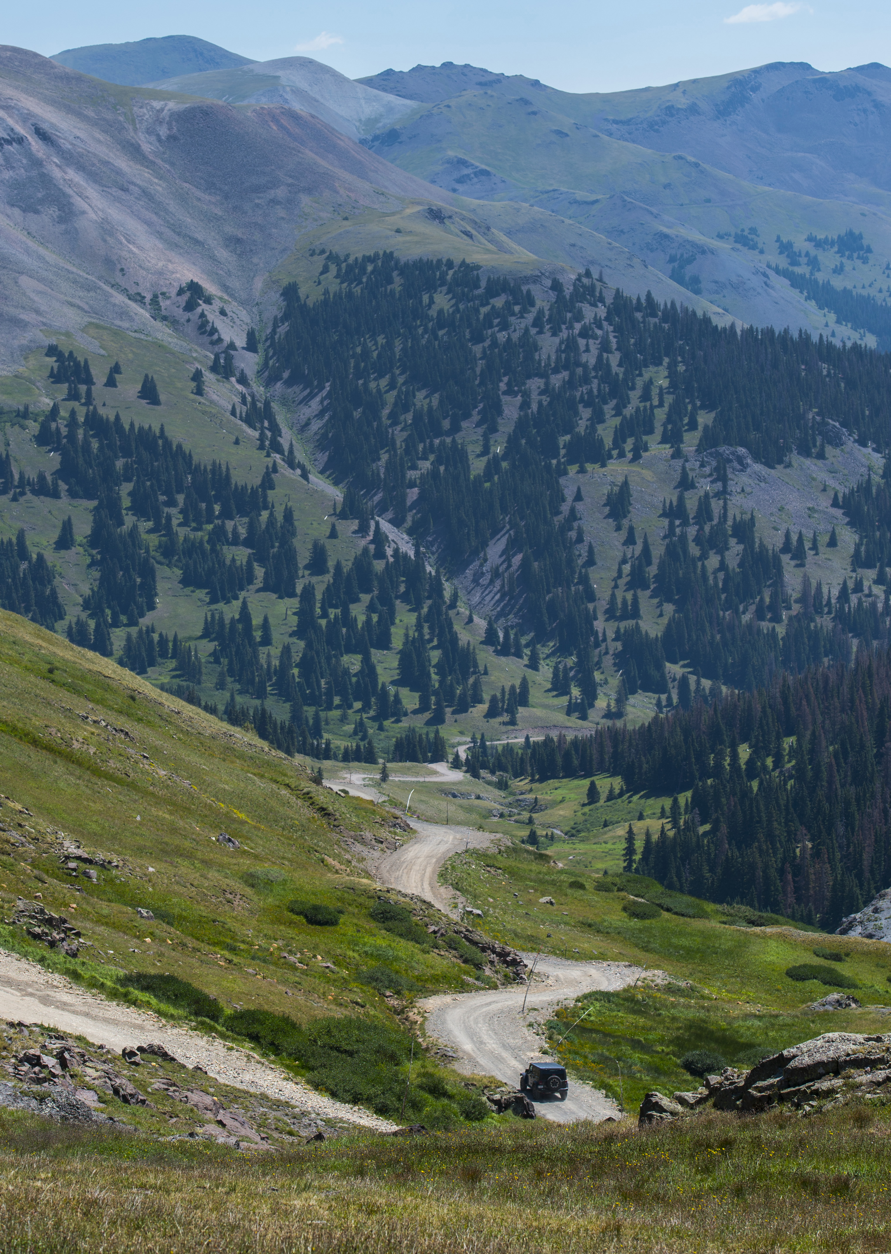 A Jeep descends Engineer Pass east of the 12,800-foot summit in July. A four-wheel drive vehicle with high ground clearance is required to reach the top of Engineer Pass. The 63-mile Alpine Loop’s full go-round takes four to six hours, the Colorado Department of Transportation says. (Christian Murdock)