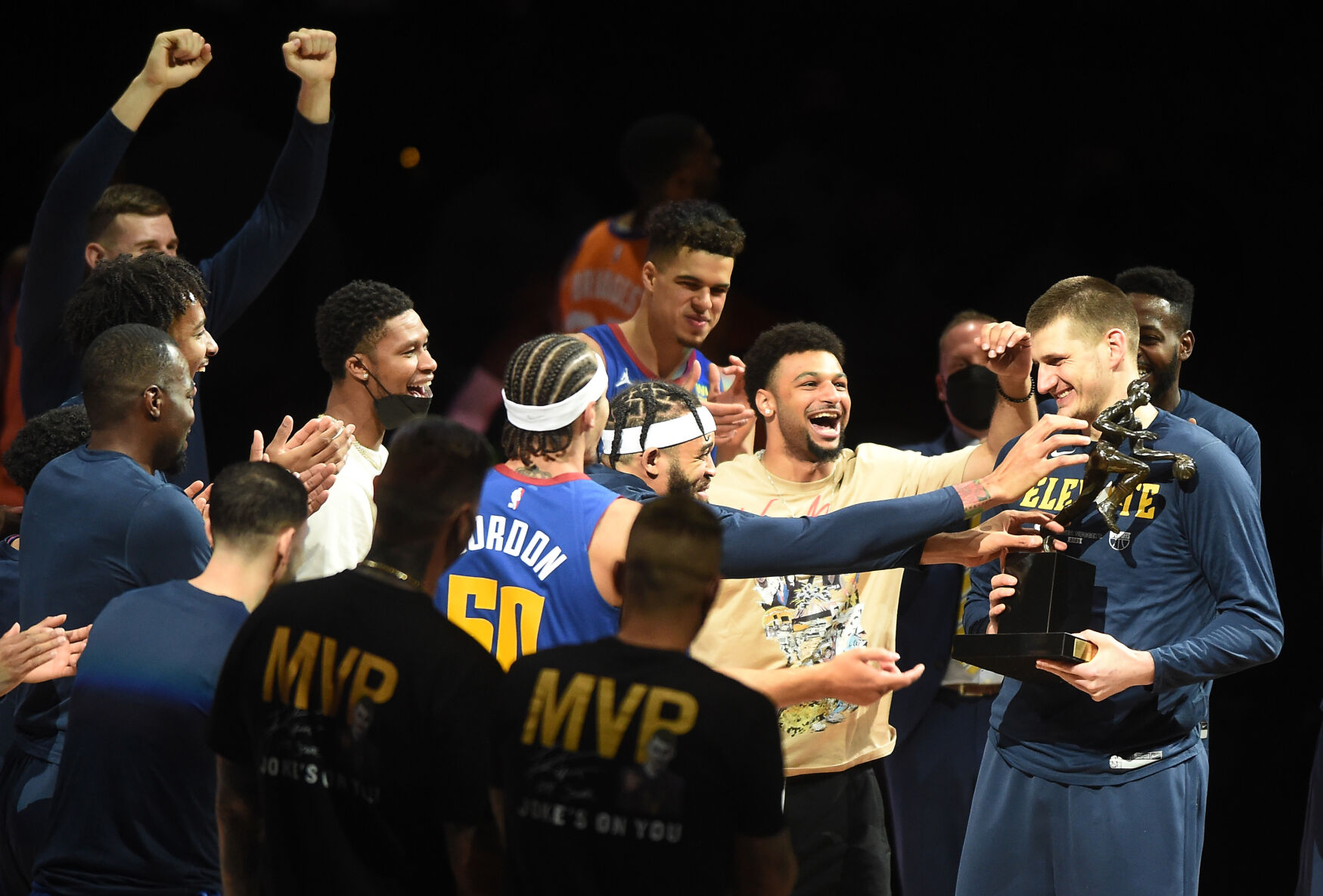 Denver’s Nikola Jokic is greeted by teammates after being presented the NBA MVP trophy before Game 3 of the conference semifinals Friday in Denver. Jokic is the first Nugget to get an MVP award and the first second-round draft pick in NBA history to earn it. (JERILEE BENNETT, The Gazette)