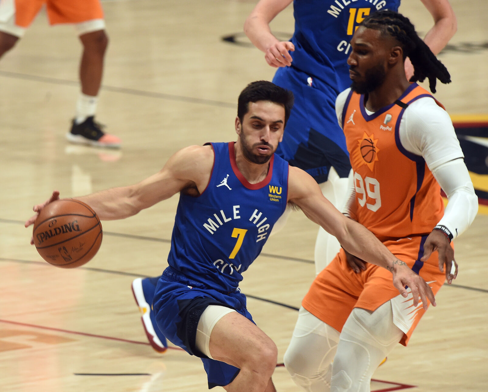 Denver’s Facu Campazzo is defended by Phoenix’s Jae Crowder after gaining possession of the ball during the second quarter of game 3 of the conference semifinals at Ball Arena on Friday, June 11, 2021. (Photo by Jerilee Bennett, The Gazette) (JERILEE BENNETT)