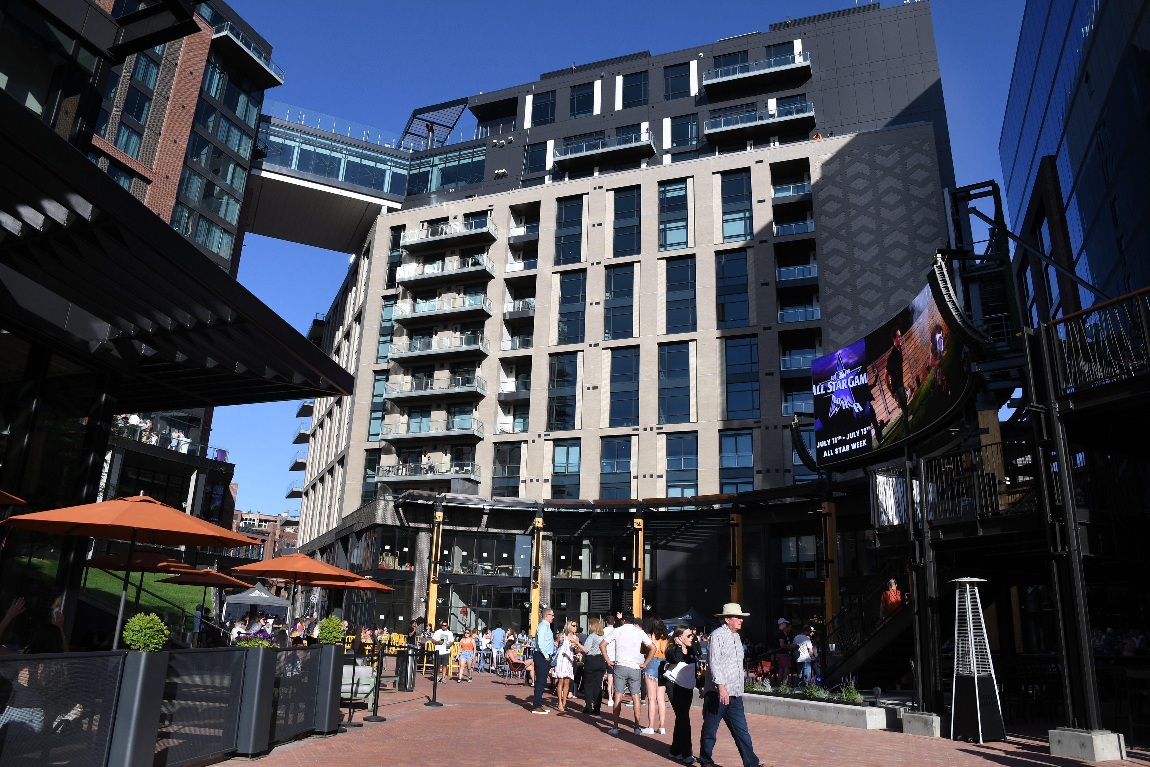 DENVER, CO - JUNE 11: Rockies fans and other visitors join a celebration in the open outdoor plaza, where a large jumbo screen will show the games in McGregor Square. McGregor Square hosts its grand opening celebration on June 11, 2021 in Denver, Colorado. The new complex, located across the street from Coors Field ballpark, includes a new hotel, luxury condos, office space, a Tattered Cover bookstore, and bars and restaurants. (Kathryn Scott, Denver Gazette)