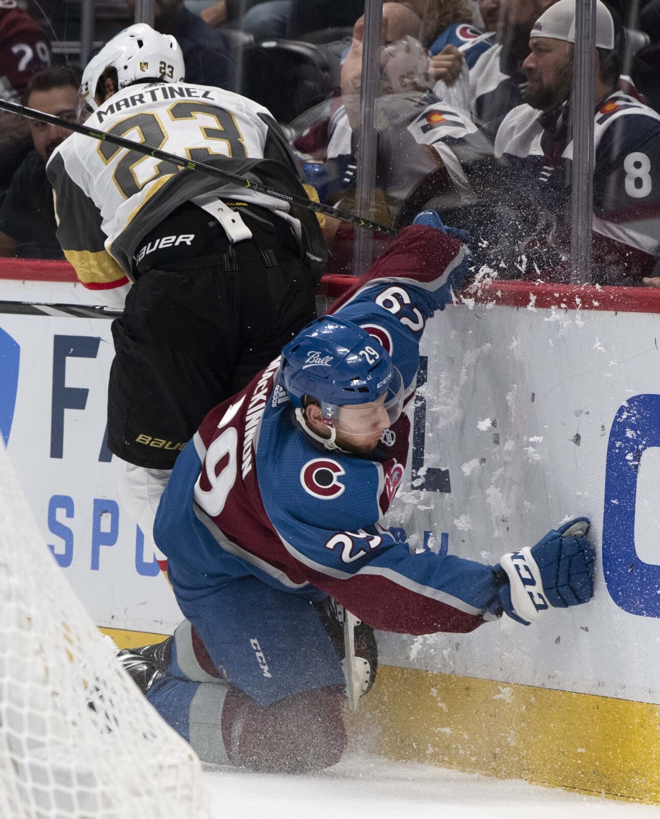 Colorado Avalanche center Nathan MacKinnon (29) and Vegas Golden Knights defenseman Alec Martinez (23) crash into the boards during the second period of game two in the second round of the Stanley Cup Playoffs Wednesday, June 2, 2021, at Ball Arena in Denver. (The Gazette, Christian Murdock) (Christian Murdock/The Gazette)