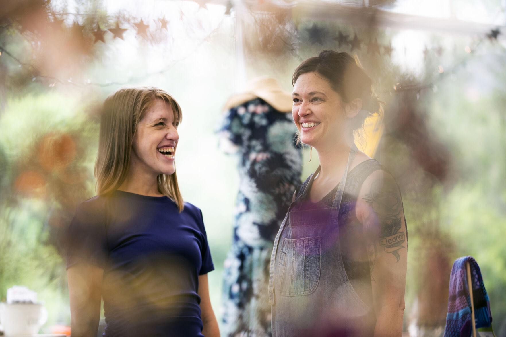 Employee Erin Bogue, left, laughs with owner Nicole O’Rorke at Barn + Swallow boutique in Manitou Spring. (Chancey Bush/ The Gazette)