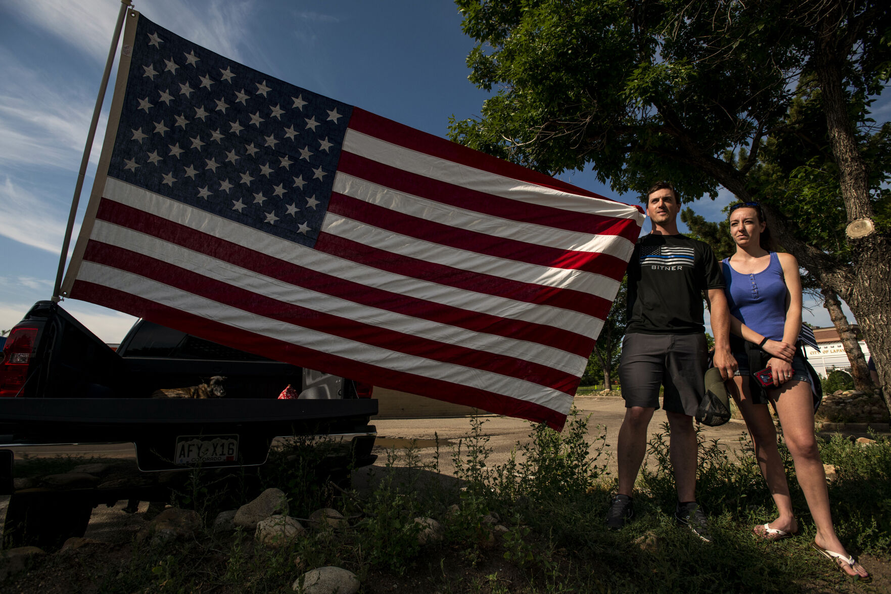 A man and woman, who did not want to give their names, pay their respects to slain Arvada police officer Gordon Beesley during a funeral procession in Lafayette, Colo., on Tuesday, June 29, 2021. A funeral was held at the Flatirons Community Church for officer Beesley, who was a 19-year veteran of the Arvada Police Department. Officer Beesley was killed by a gunman in Olde Town Arvada plaza on June 21, 2021. (Chancey Bush/ The Gazette) (Chancey Bush)