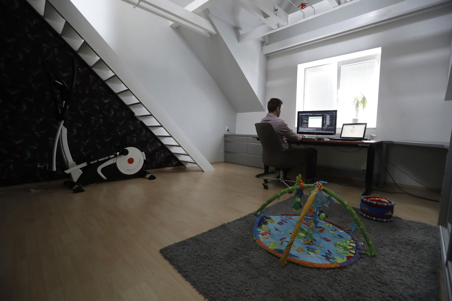 A remote worker sits at his computer at his home in this Associated Press file photo. (Petr David Josek)