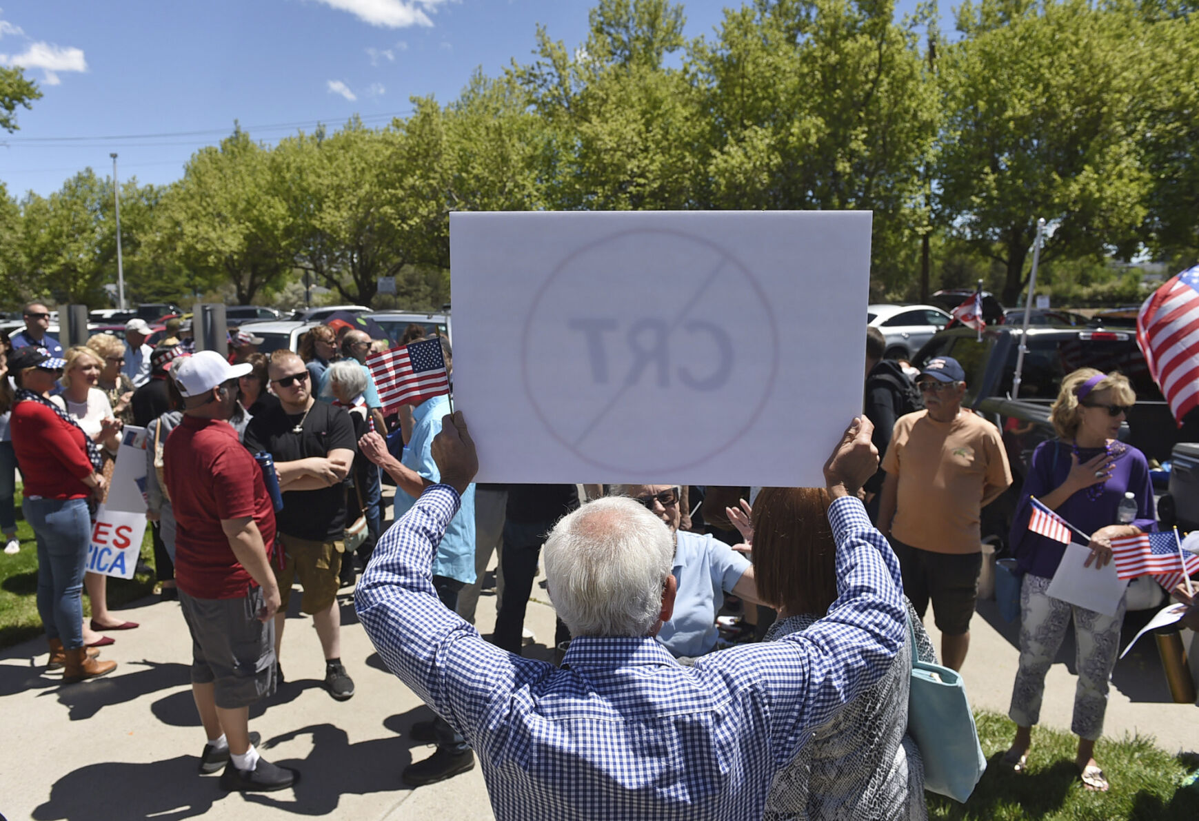 A demonstrator holds up a sign against Critical Race Theory during a protest May 25 outside a Washoe County School District board meeting in Reno, Nev. (The Associated Press)