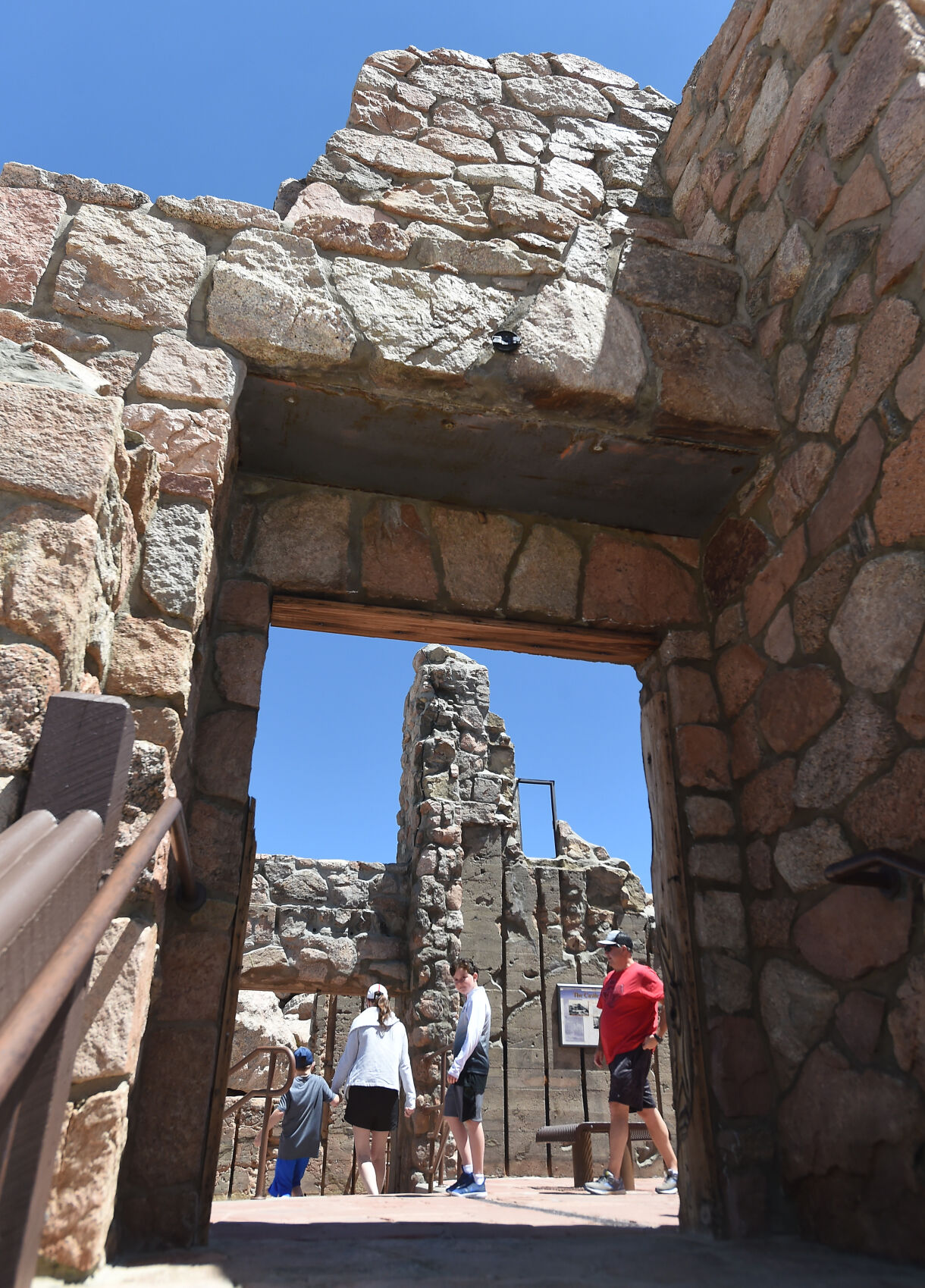 A family explores the ruins of the Castle in the Sky at the summit of Mt. Evans on Thursday. June 9, 2021. Last Summer the highway to the summit of Mt. Evans was closed to motorized vehicles due to Covid concerns. The road is back open this summer, but paid reservations must be made ahead of time online at recreation.gov. (Photo by Jerilee Bennett, The Gazette) (Photo by Jerilee Bennett, The Gazette) (JERILEE BENNETT)