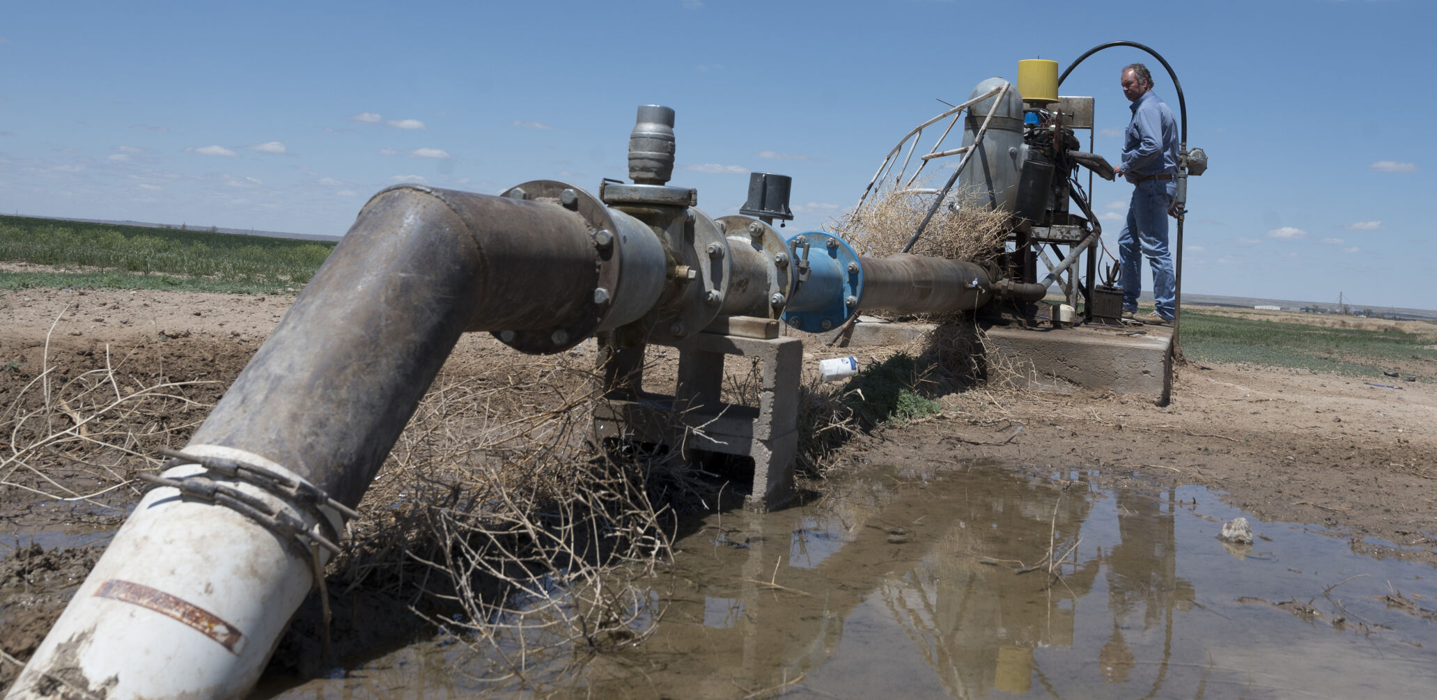 Rancher and farmer Keith Simon checks on one of the pumps that are still able to produce water for irrigation and cattle on his ranch. (photos by JERILEE BENNETT, THE denver GAZETTE)