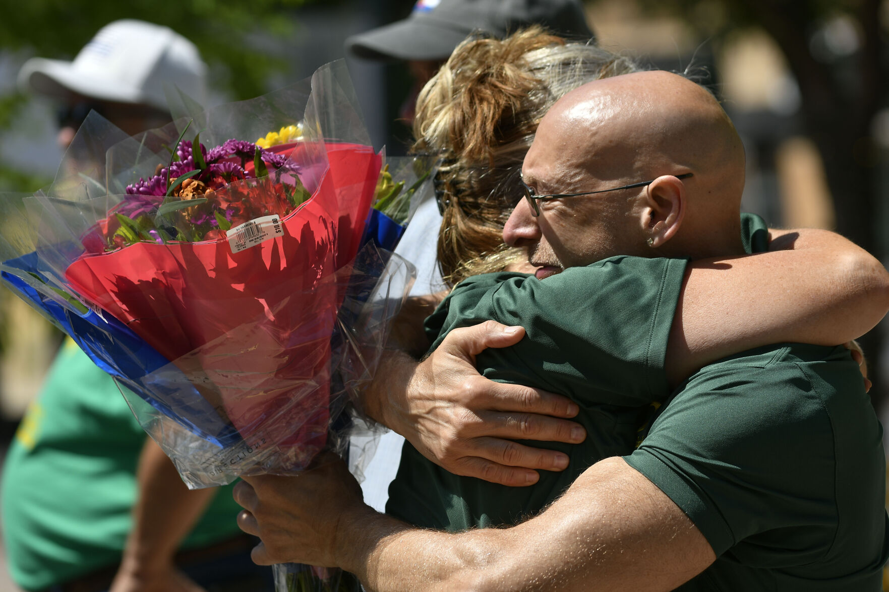 JUNE 22, 2021 - David Ruppert, Counselor at Oberon Middle School embraces a staff member as they gather at the fountain in Olde Town Arvada where a shooting left three people dead, including Arvada veteran police officer Gordon Beesley, another person was also killed after being shot by the gunman and the suspect was also shot and killed. The staff from Oberon Middle School marched to the police station where the officers patrol car is on display covered with flowers and several flags. (Photo by John Leyba) (John Leyba)