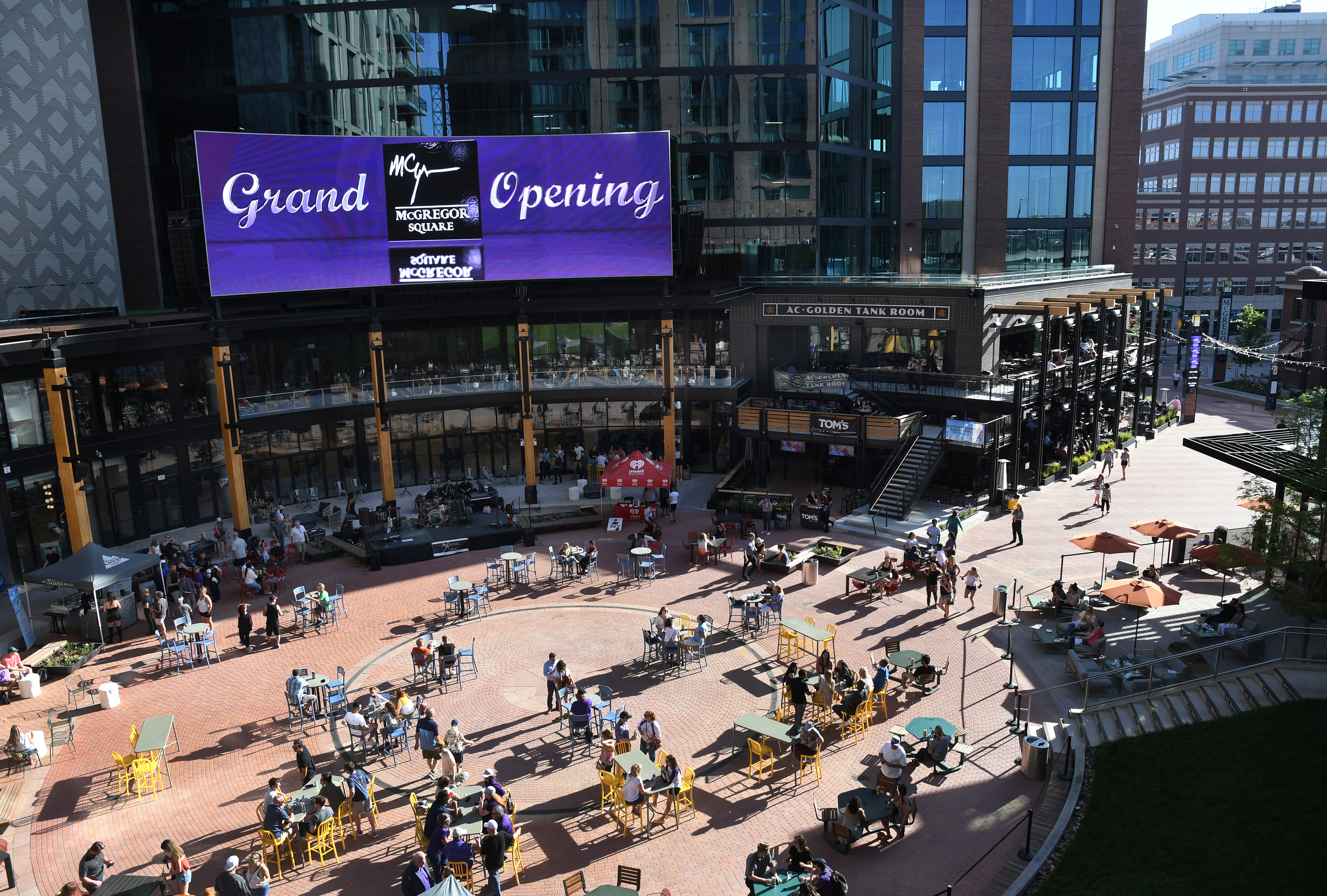DENVER, CO - JUNE 11: Rockies fans and other visitors join a celebration in the open outdoor plaza, where a large jumbo screen will show the games in McGregor Square. (Kathryn Scott, Denver Gazette)