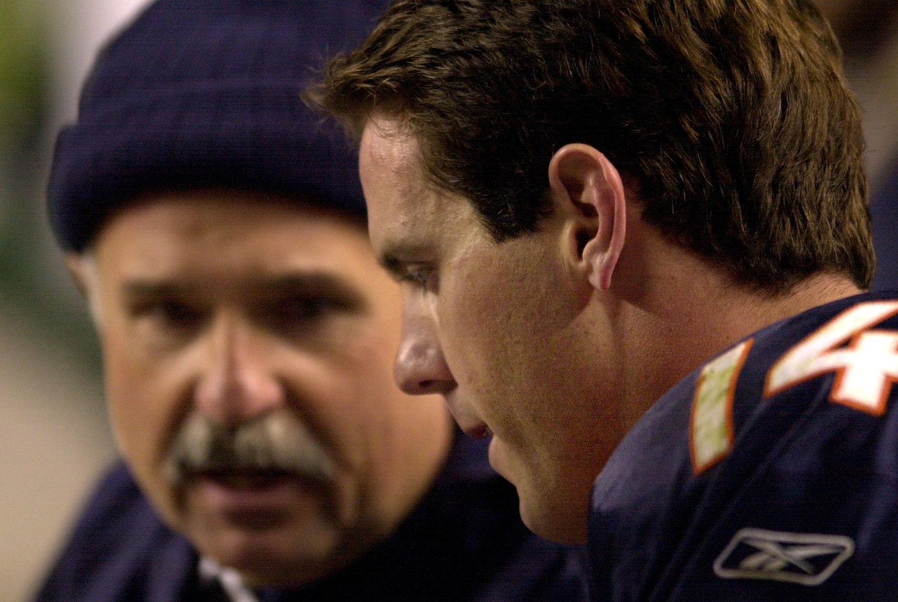 Bronco quarterback Brian Griese listens to trainer Steve Antonopoulos after leaving the game Dec. 9, 2001. Mark Reis photo (Mark Reis)