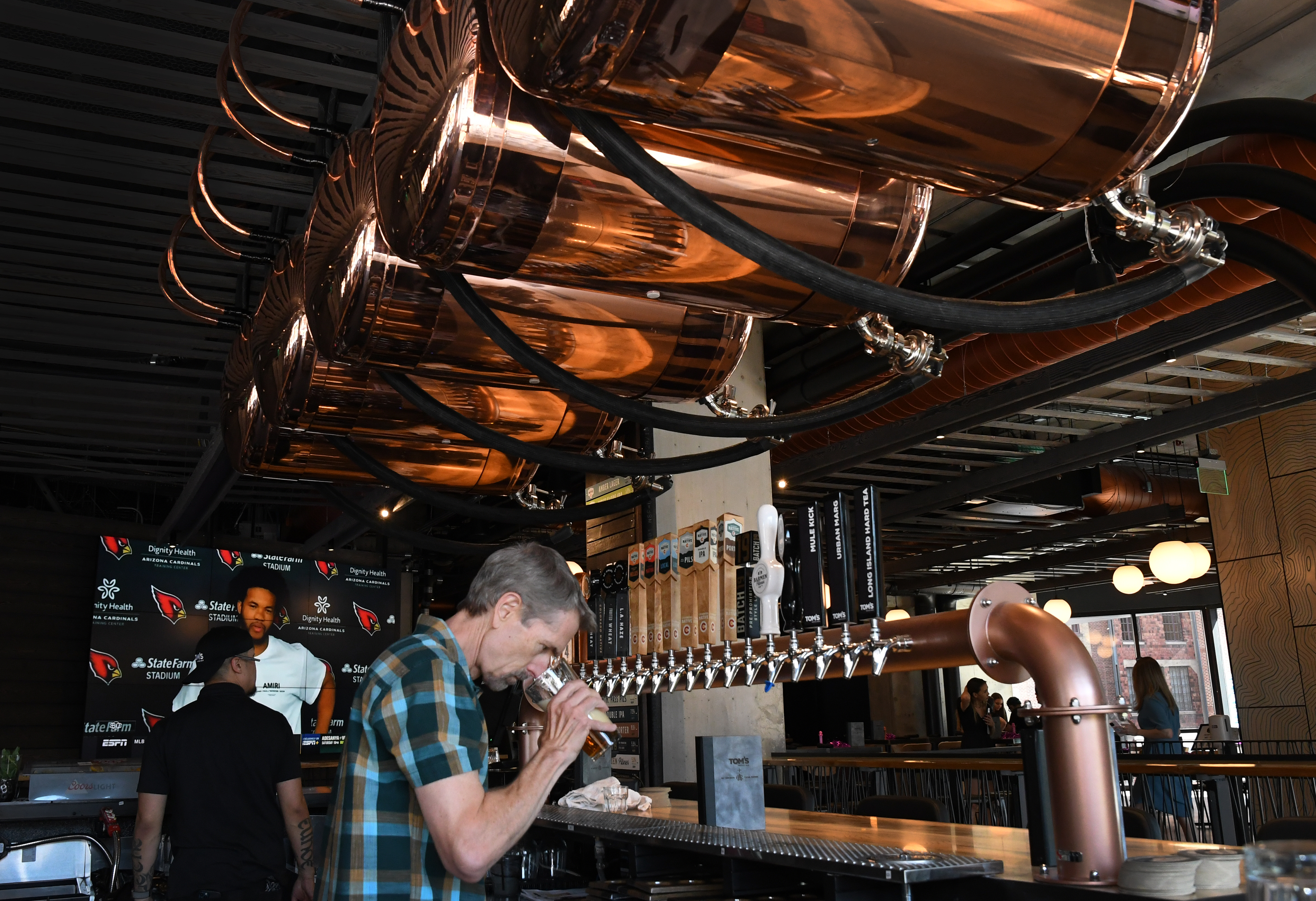 DENVER, CO - JUNE 11: Jeff Cornell, the general manager for AC Golden Brewing Co, tests some of the beers on tap just in time for the Tom’s Watch Bar soft opening. The brewery is located upstairs in Tom’s restaurant/bar. McGregor Square hosts its grand opening celebration on June 11, 2021 in Denver, Colorado. The new complex, located across the street from Coors Field ballpark, includes a new hotel, luxury condos, office space, a Tattered Cover bookstore, and bars and restaurants. (Kathryn Scott, Denver Gazette)