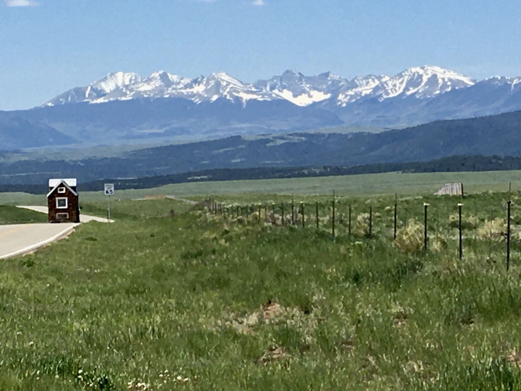 A truck pulls a tiny house along State Highway 69 in the Wet Mountain Valley. (Vince Bzdek)