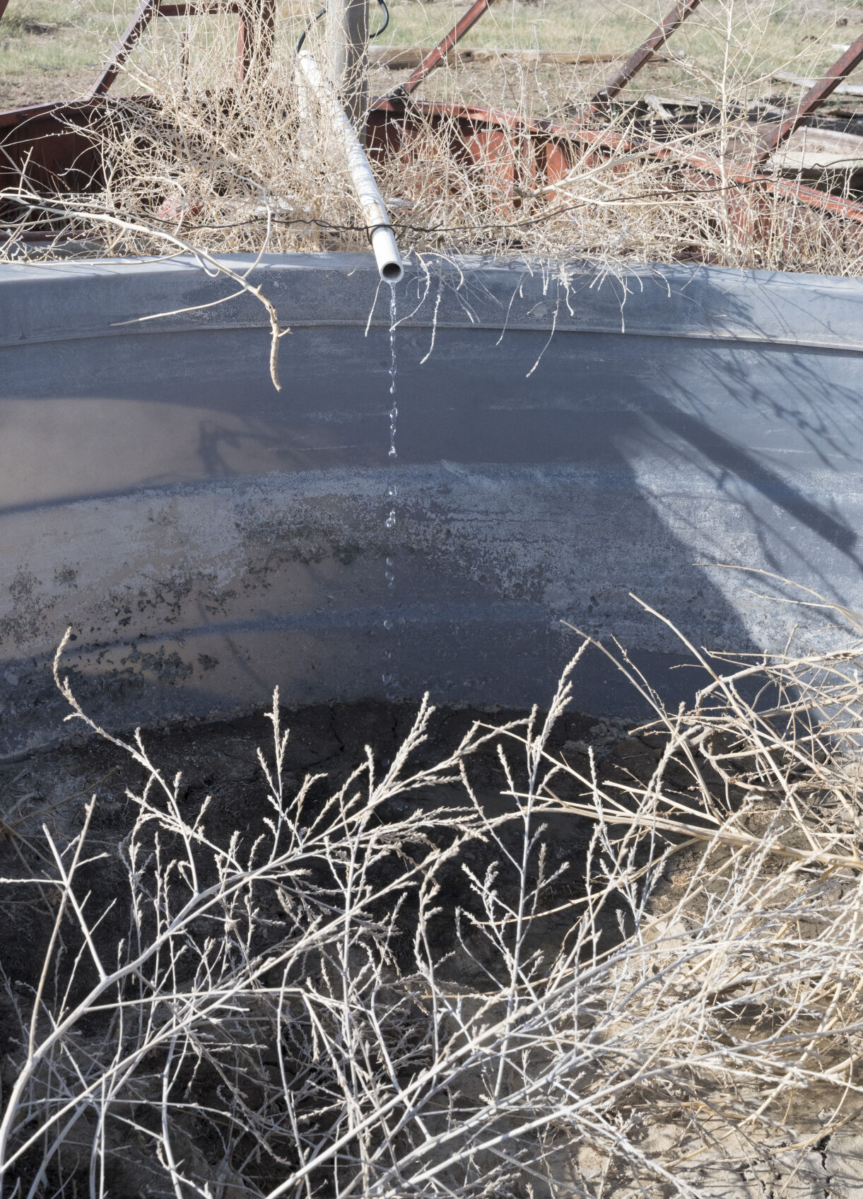 Water trickles from the pipe of a well that no longer produces enough water to run the pump at a ranch in Baca County. (Photo by Jerilee Bennett, The Gazette) (JERILEE BENNETT THE GAZETTE)