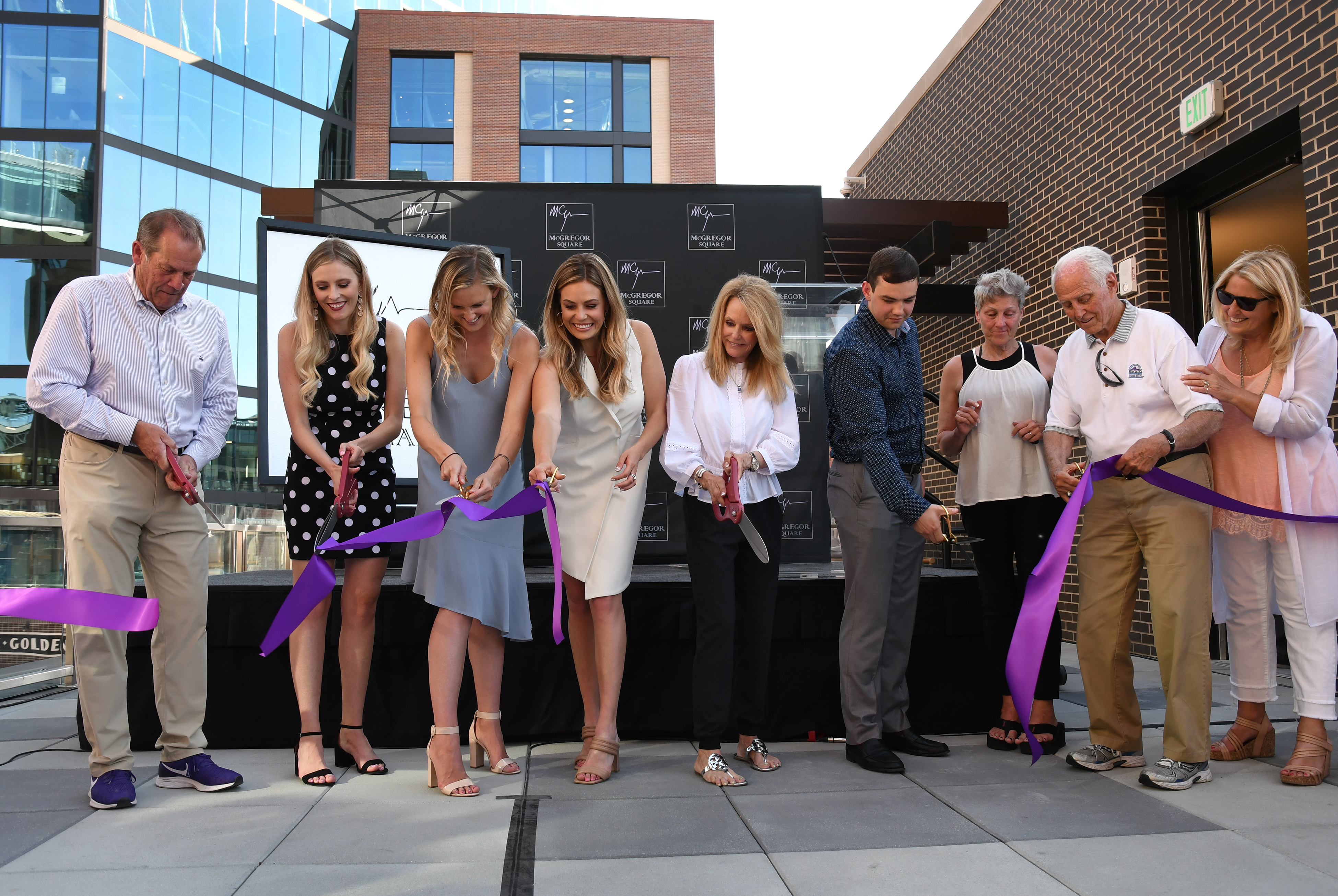 DENVER, CO - JUNE 11: Colorado Rockies owner, chairman and CEO Dick Monfort, left, joins Lori McGregor, center, and other members of the McGregor family, for a ribbon cutting ceremony to mark the grand opening of McGregor Square on June 11, 2021 in Denver, Colorado. McGregor Square is named after the Rockies’ late president Keli McGregor, who passed away in April of 2010. The new complex, located across the street from Coors Field ballpark, includes a new hotel, luxury condos, office space, a Tattered Cover bookstore, and bars and restaurants. (Kathryn Scott, Denver Gazette)