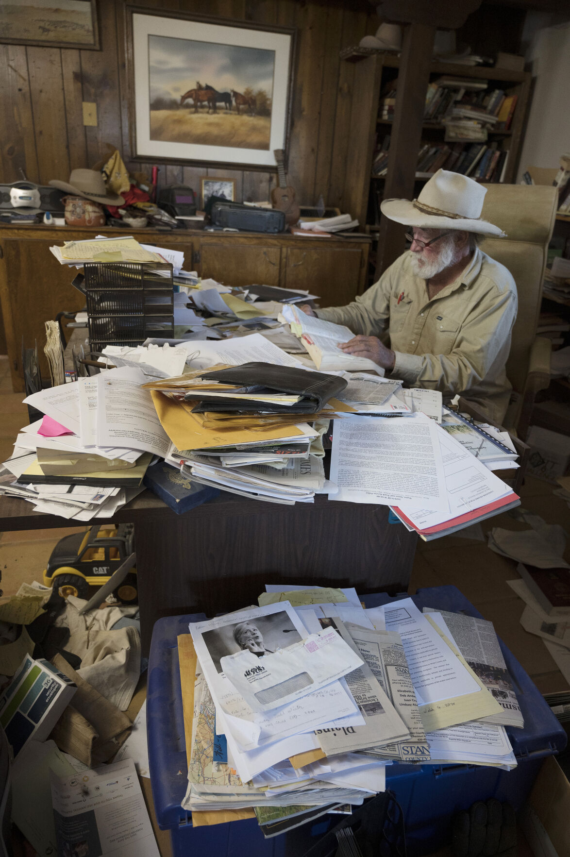 Wes McKinley goes through some of the paperwork in which he objected to over 50 wells but he has barred from submitting more objections. Now some 20 other people are trying to submit objections. Most of the wells are being built by a company called LGS Holdings..(Photo by Jerilee Bennett, The Gazette) (JERILEE BENNETT THE GAZETTE)