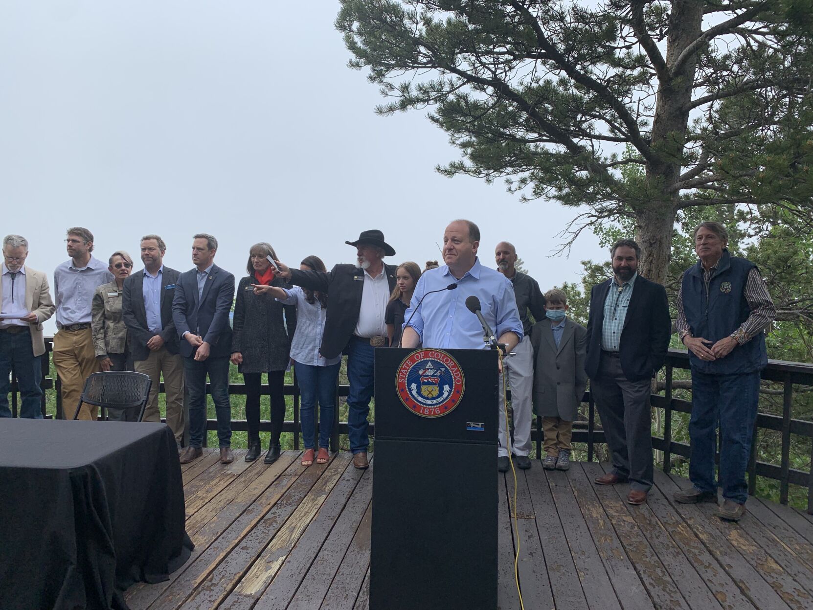 Gov. Jared Polis, surrounded by lawmakers and state parks officials during the signing of three parks bills at Golden Gate Canyon State Park's Panorama Point, which on a clear day allows visitors to see for miles. Not on June 21, 2021, however. (MarianneGoodlandmarianne.goodland@coloradopolitics.comhttps://secure.gravatar.com/avatar/125a14b7bd9266f61a445ec13b1d3605?d=mm&r=g)