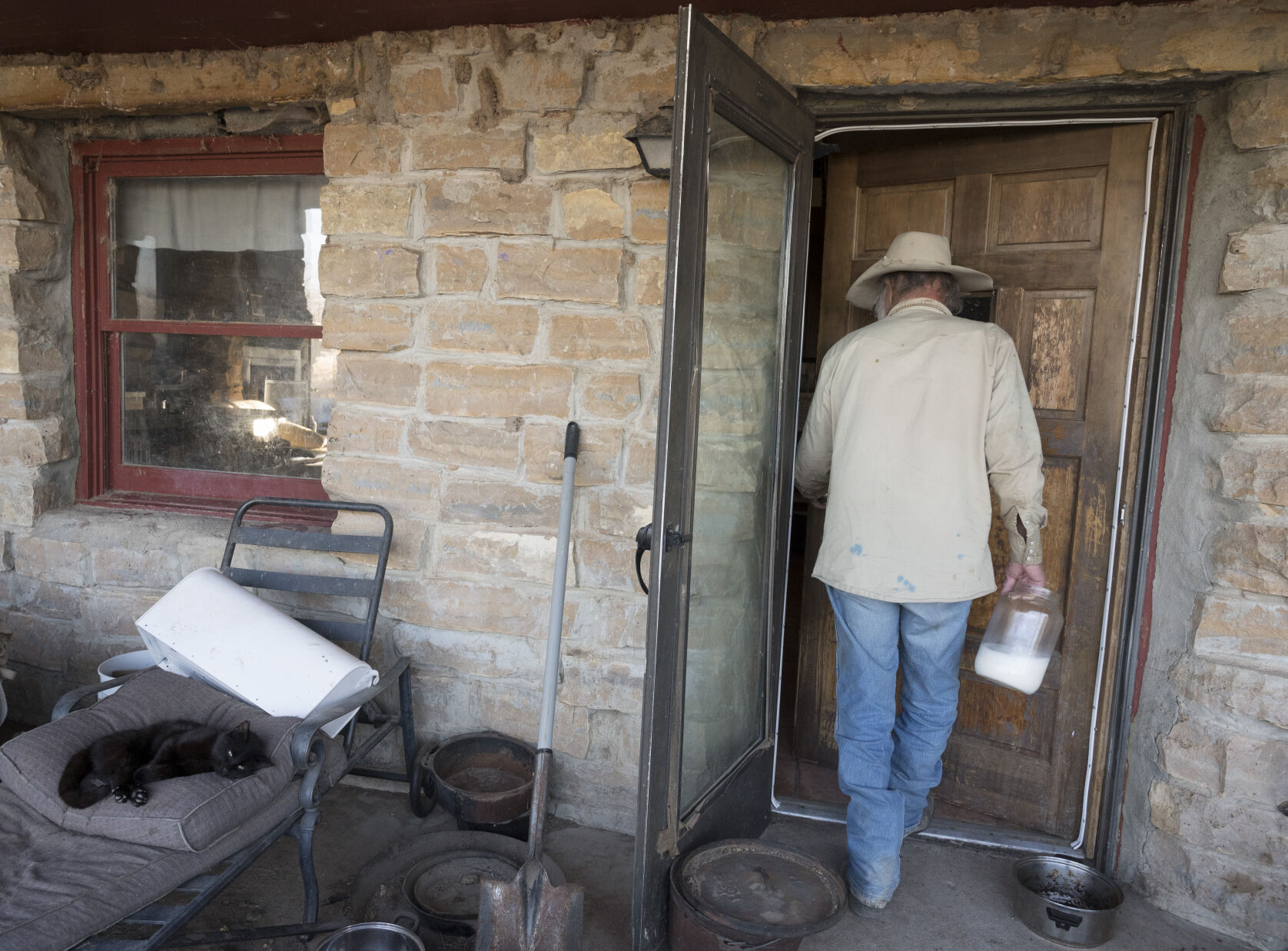 Wes McKinley carries goat milk into his home in Baca County. McKinley has objected to over 50 wells but he has barred from submitting more objections. Now some 20 other people are trying to submit objections. Most of the wells are being built by a company called LGS Holdings.(Photo by Jerilee Bennett, The Gazette) (JERILEE BENNETT THE GAZETTE)