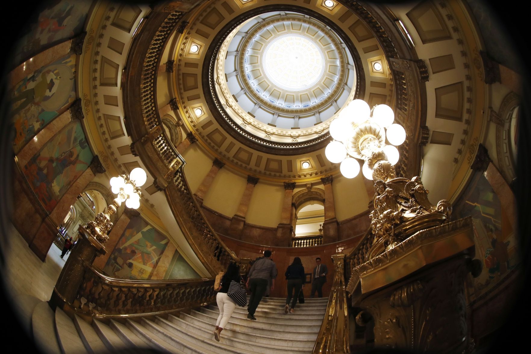 As viewed through a fisheye lens, visitors head up the stairs in the rotunda in the state Capitol on May 2, 2019. State lawmakers wrapped up its regular session the next day. (File photo by David Zalubowski, Associated Press)