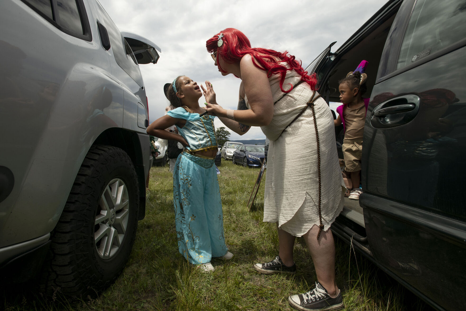 Noelle Luketu, 7, has glitter applied to her lips by her mother Miranda Sutherland during opening day of the 2021 Colorado Renaissance Festival in Larkspur, Colo., on July 3, 2021. The festival is back for their 44th season after being postponed by the COVID-19 pandemic last year. The Renaissance Festival is open for eight themed weekends, Saturdays and Sundays, through Aug. 22 in Larkspur, 650 W. Perry Park Ave. 10 a.m.-6:30 p.m. (Chancey Bush/ The Gazette) (Chancey Bush/ The Gazette)