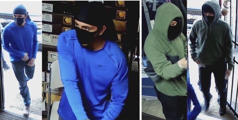 Police searching for two men who displayed handguns during a robbery