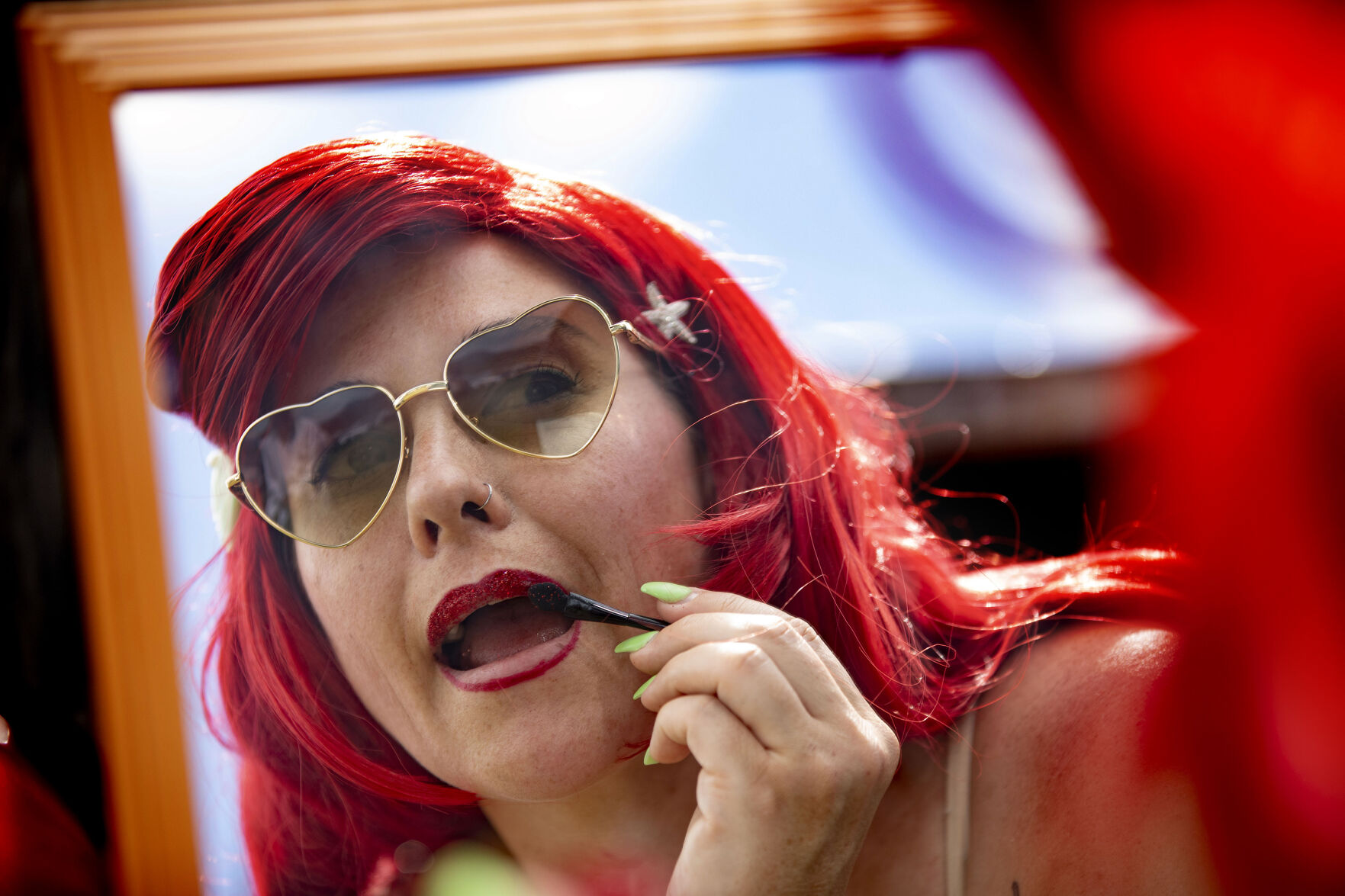 Miranda Sutherland adds glitter to her lips in the parking meadow during opening day of the 2021 Colorado Renaissance Festival in Larkspur, Colo., on July 3, 2021. The festival is back for their 44th season after being postponed by the COVID-19 pandemic last year. The Renaissance Festival is open for eight themed weekends, Saturdays and Sundays, through Aug. 22 in Larkspur, 650 W. Perry Park Ave. 10 a.m.-6:30 p.m. (Chancey Bush/ The Gazette) (Chancey Bush/ The Gazette)