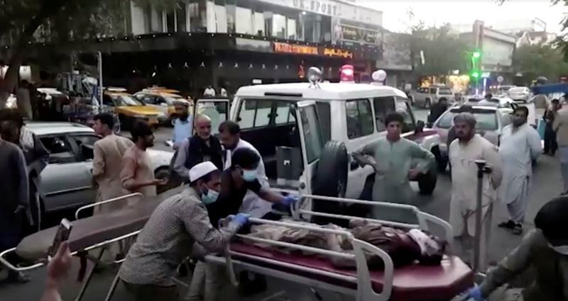 A screen grab shows people carrying an injured person to a hospital after an attack at Kabul airport, in Kabul, Afghanistan August 26, 2021. REUTERS TV/1TV/Handout via REUTERS (REUTERS TV/1TV)
