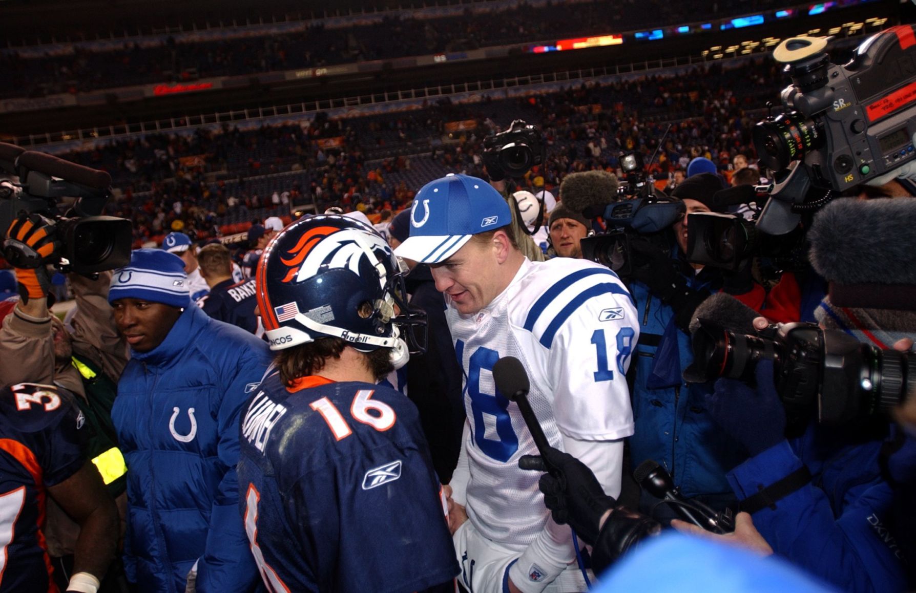 Denver quarterback Jake Plummer and Colts starting quarterback Peyton Manning greet each other at mid field after the Broncos defeated the Colts 33-14 at Invesco Field at Mile High in Denver, Colo., Jan, 2, 2005. The two quarterback will meet next week in Indianapolis in the first round of the playoffs. Photo by Christian Murdock/The Gazette (murdock)