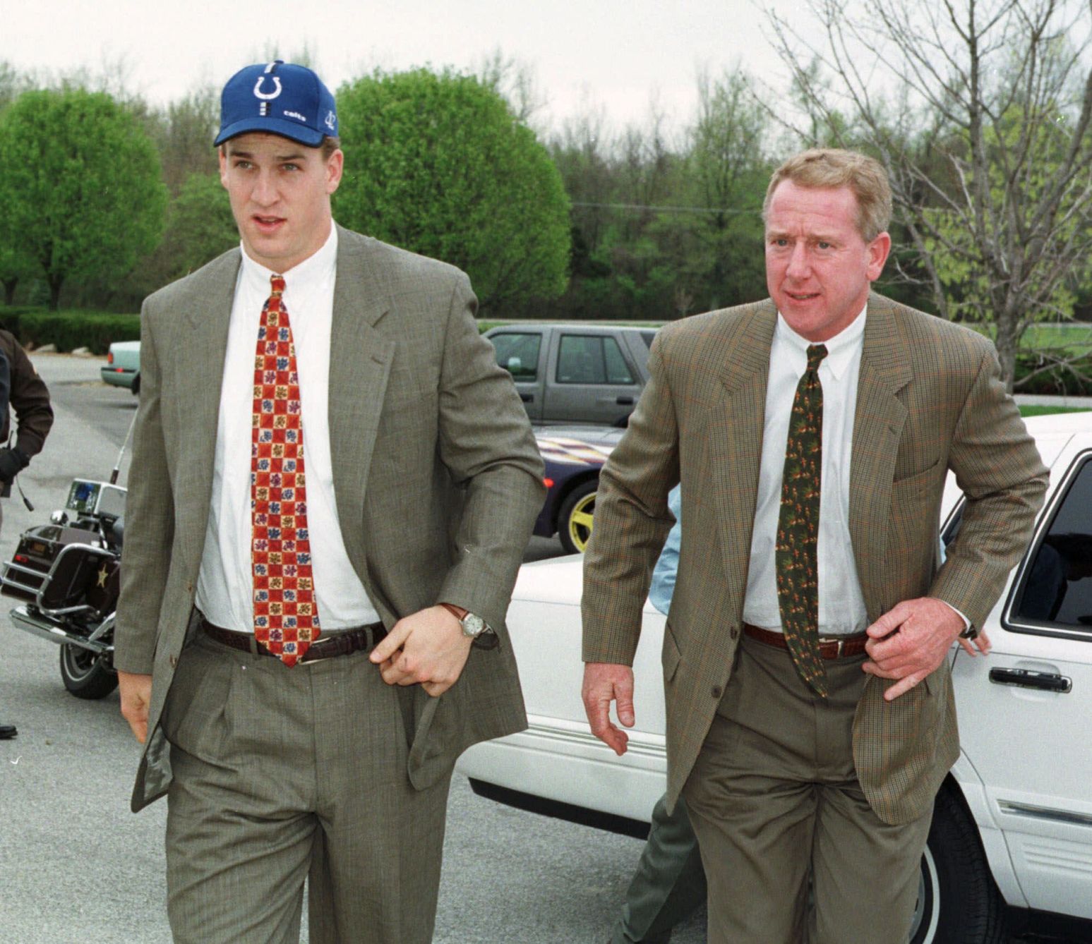 Peyton Manning, the No. 1 pick in the NFL draft by the Indianapolis Colts, and his father Archie, right, arrive at the Colts' headquarters Indianapolis, April 18, 1998. Now, late in a second season like no NFL quarterback has had since Dan Marino in 1984, Peyton Manning is becoming the pro superstar his father never quite became. (AP Photo/Michael Conroy) (MICHAEL CONROY)