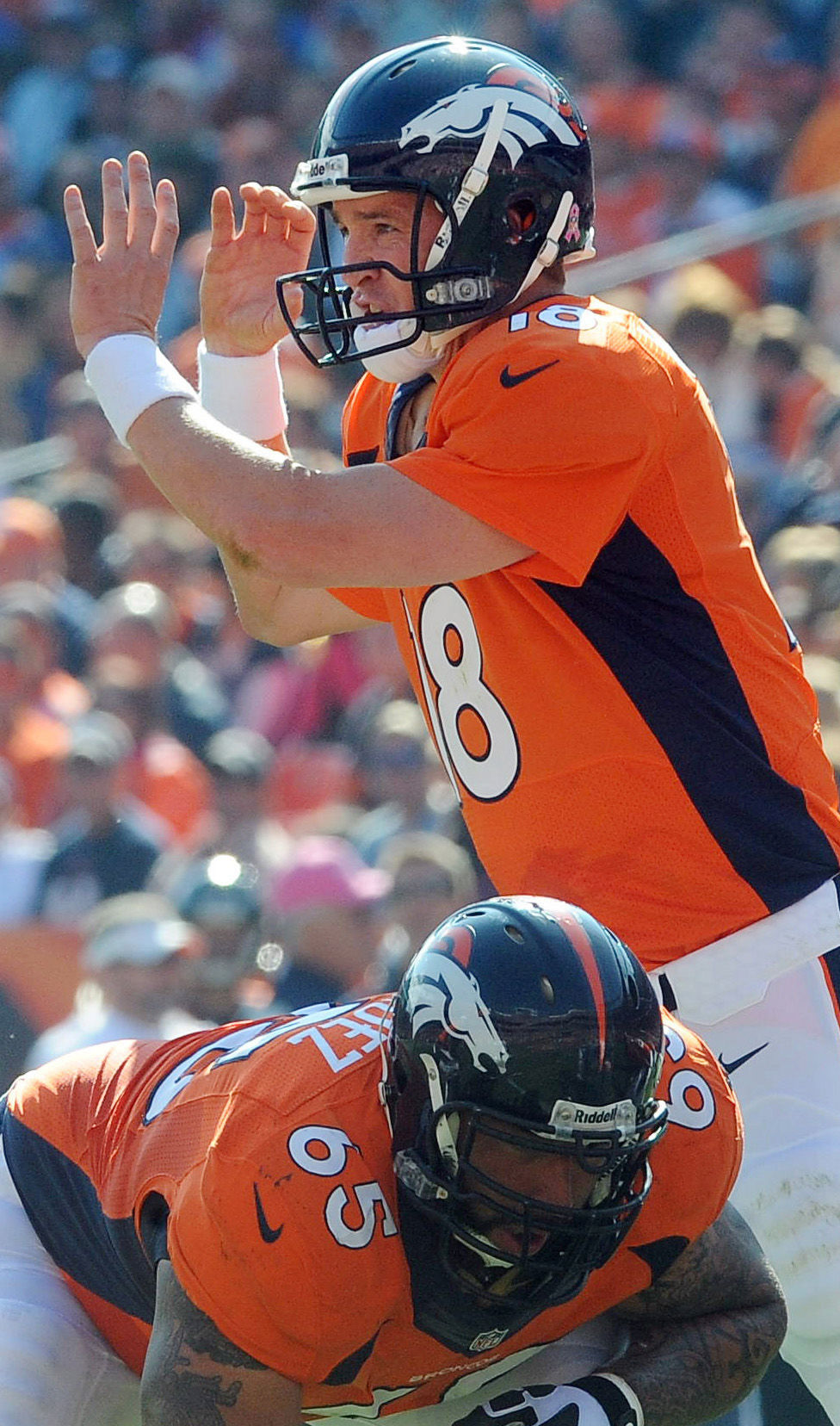 Broncos quarterback Peyton Manning makes some of his interesting hand motions from the huddle during the second quarter of a game against Jacksonville. The Broncos defeated the Jaguars 35-19 at Sports Authority Field at Mile High on Sunday, October 13, 2013.. (The Gazette/Jerilee Bennett) (JERILEE BENNETT)