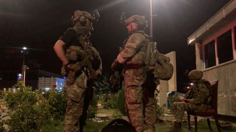 Troops keep watch at Kabul airport, Afghanistan, August 23, 2021, in this still image taken from video. Video taken August 23, 2021. REUTERS/via Reuters TV (REUTERS TV)