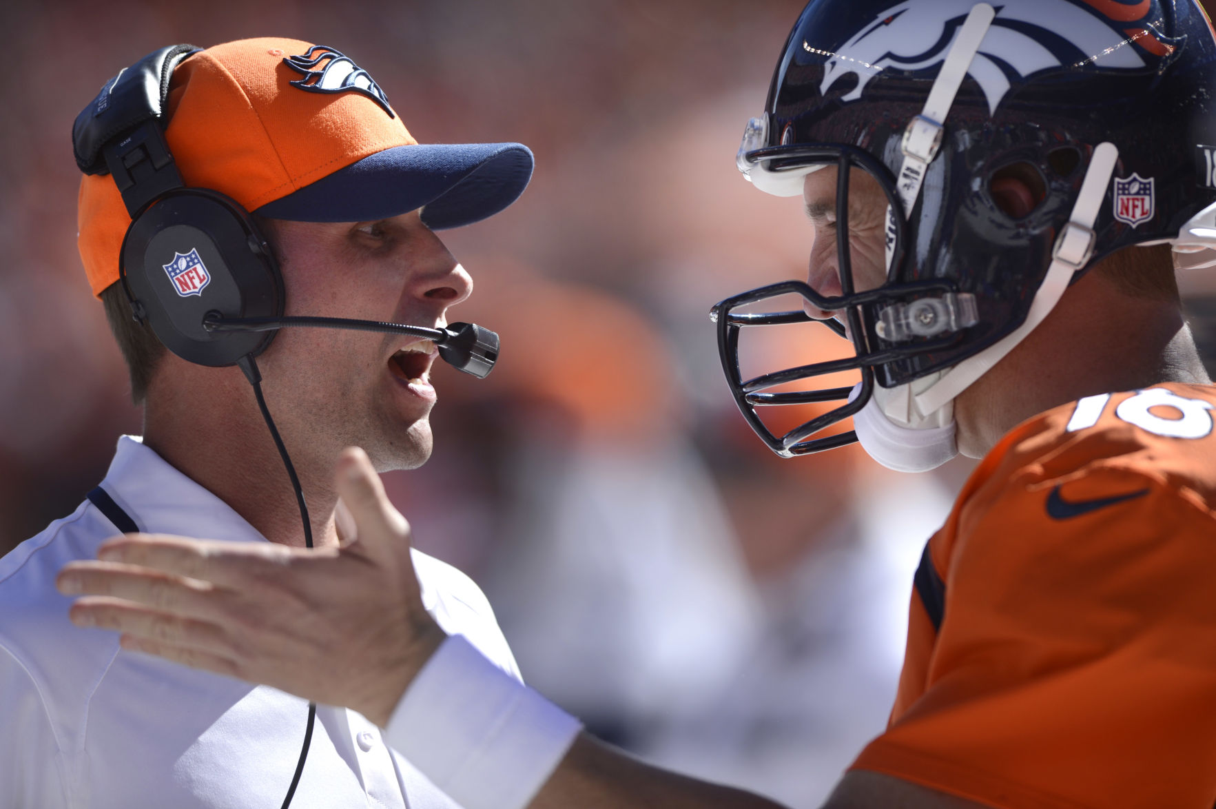 Broncos offensive coordinator Adam Gase confers with Peyton Manning in the first half of Denver's 52-20 win over the Eagles Sunday, September 29, 2013 at Sports Authority Field at Mile High. Photo by Mark Reis, The Gazette (MARK REIS)