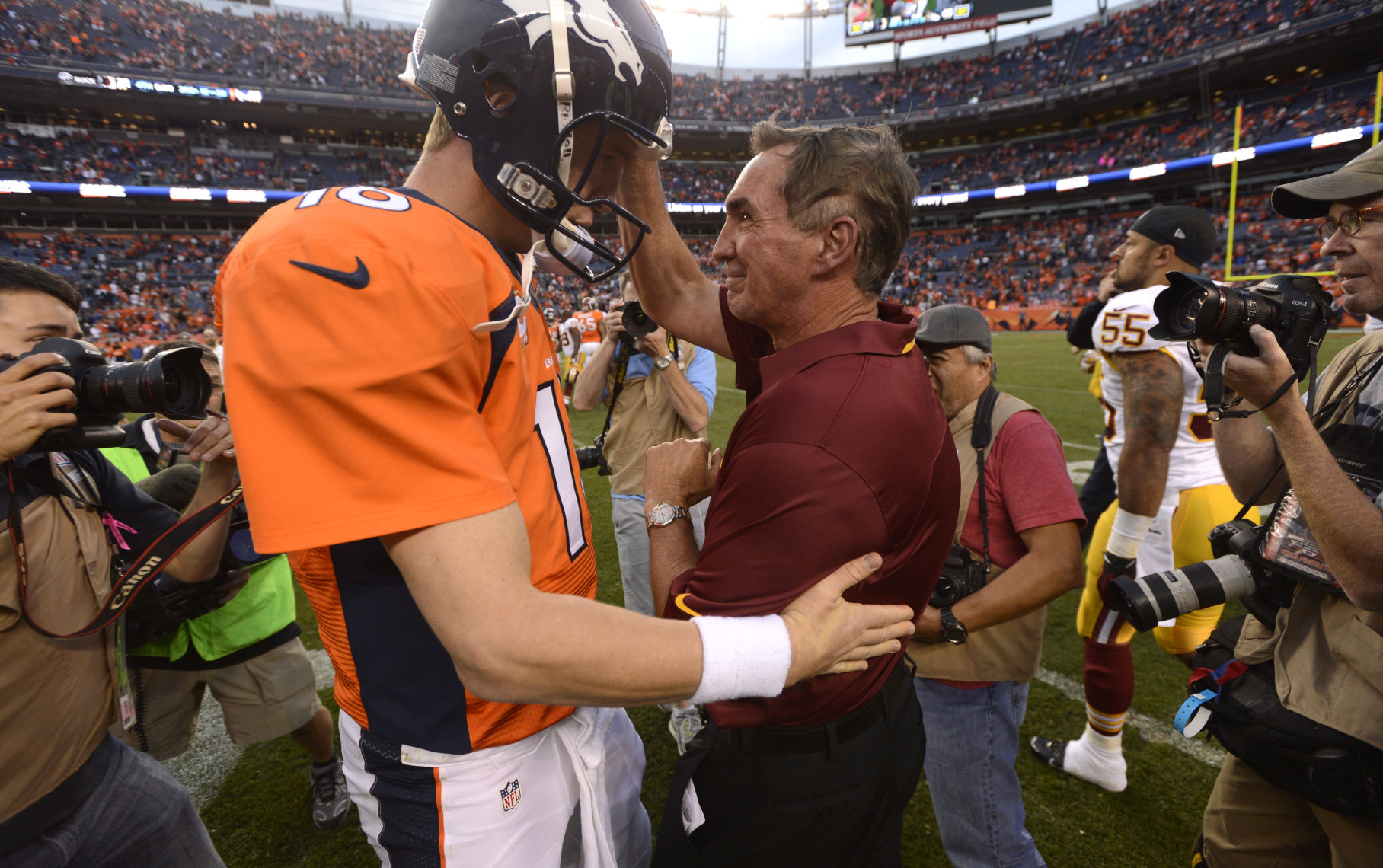 Redskins coach Mike Shanahan, right, congratulates Peyton Manning after the Broncos defeated the Redskins 45-21 on Shanahan's first return to Denver Sunday, October 27, 2013 at Sports Authority Field at Mile High. Photo by Mark Reis, The Gazette (MARK REIS)