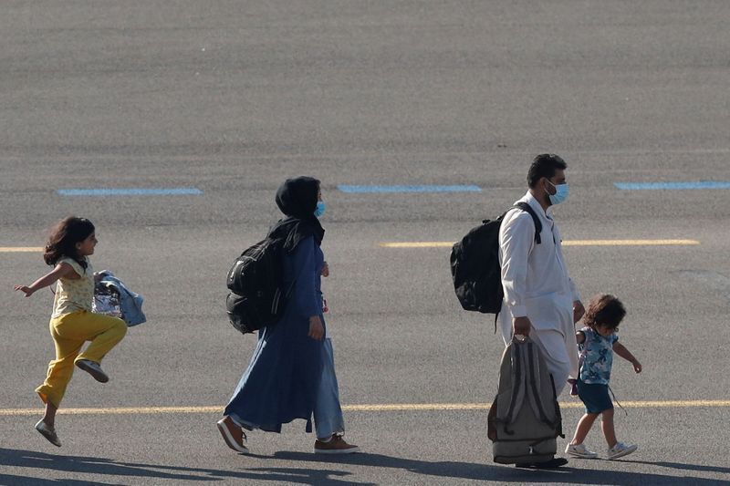 People who have been evacuated from Afghanistan arrive at Melsbroek military airport after Taliban insurgents entered Afghanistan's capital Kabul, Melsbroek, Belgium, August 25, 2021. REUTERS/Johanna Geron (JOHANNA GERON)