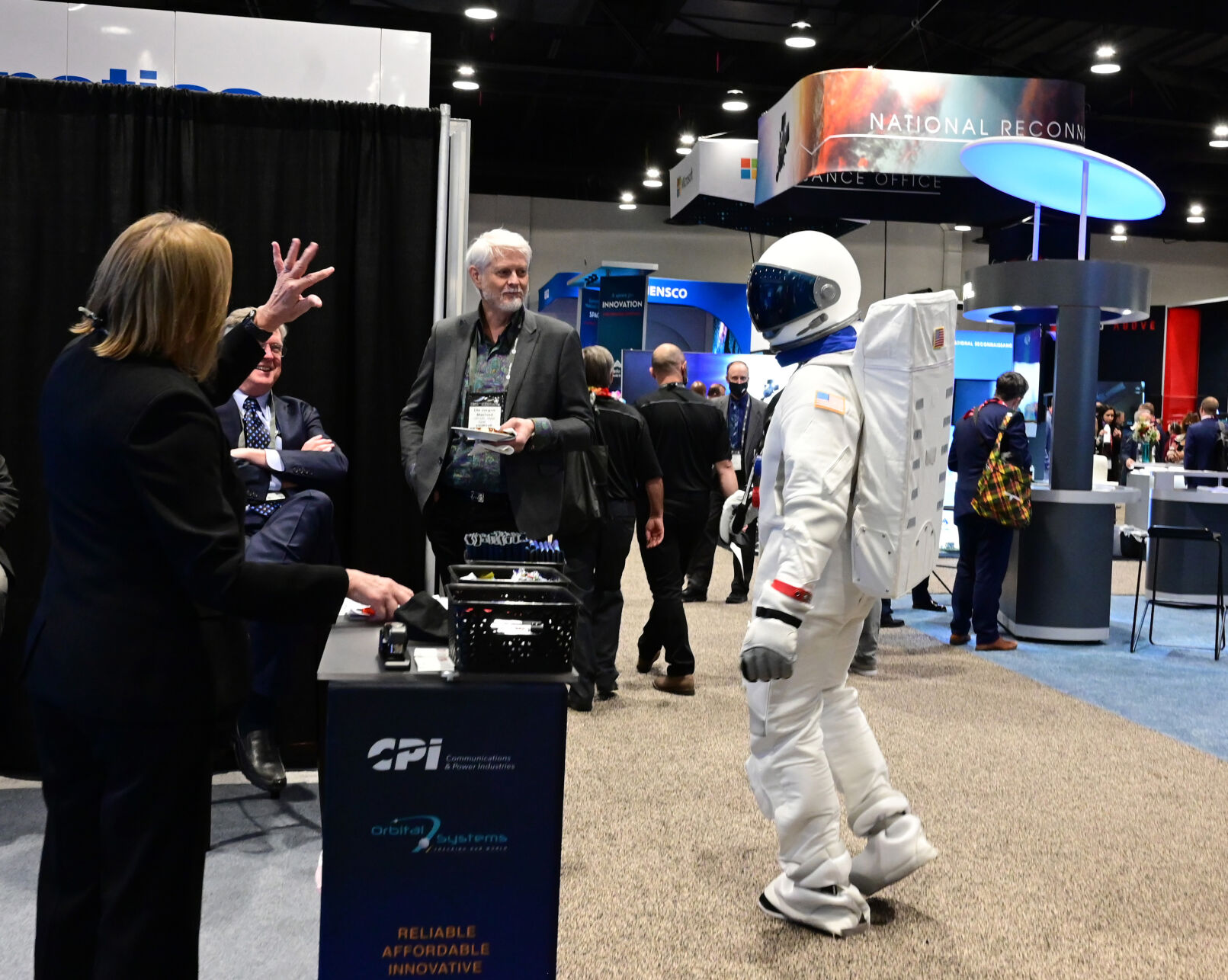 Even an astronaut likes to check out the swag at the other exhibits at the Space Symposium at the Broadmoor Hotel. Michael Ballantyne from the Global Space Exchange exhibit was checking out the other exhibits on Tuesday, Aug. 24, 2021. (Photo by Jerilee Bennett, The Gazette) (JERILEE BENNETT THE GAZETTE)