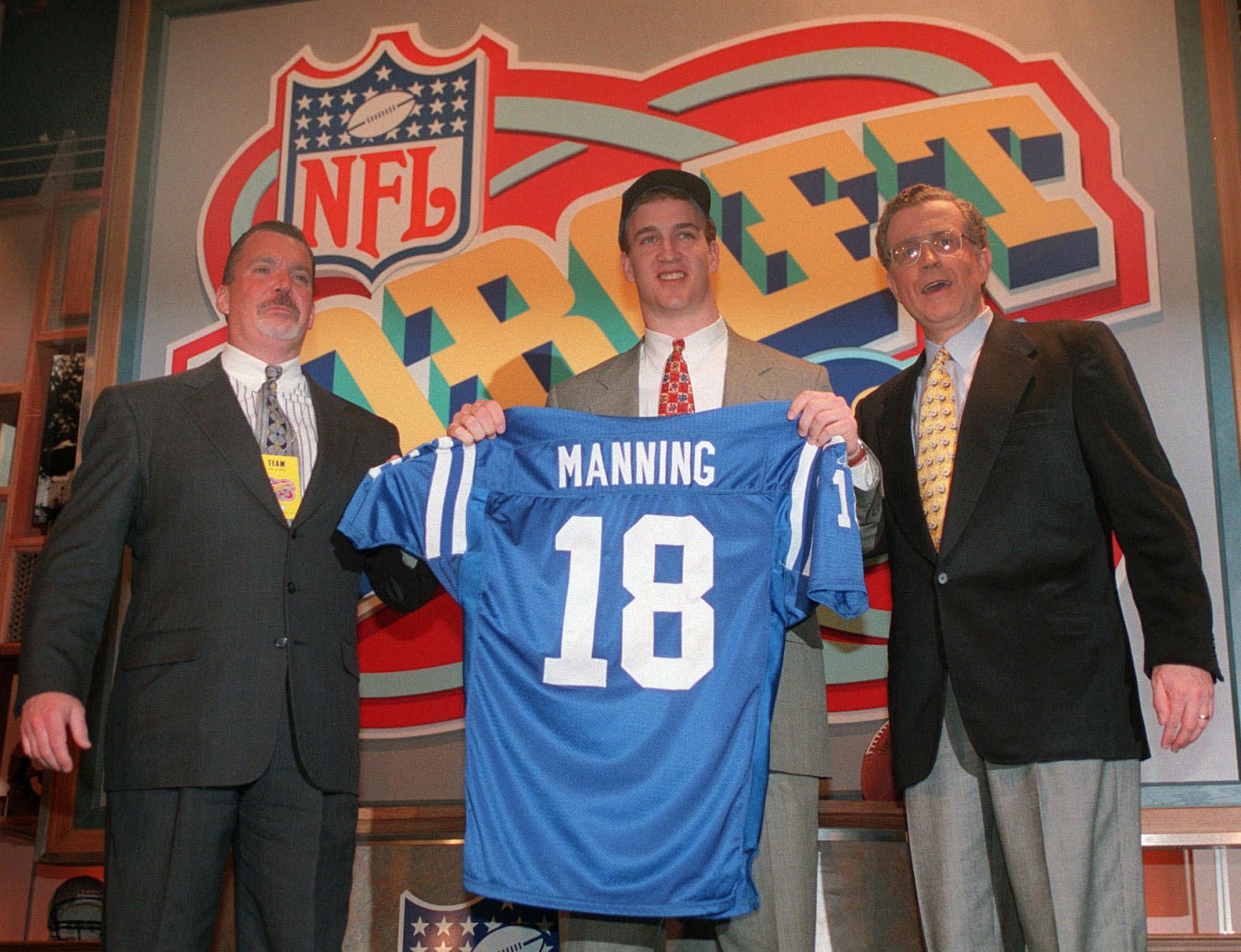 Quarterback Peyton Manning, of Tennissee, holds holds up an Indianapolis Colts jersey as he is flanked by Colts owner Jim Irsay, left, and NFL Commissioner Paul Tagliabue Saturday, April 18, 1998, in New York after being chosen by the Colts as the No. 1 pick in the in draft Saturday. (AP Photo/Adam Nadel) (ADAM NADEL)
