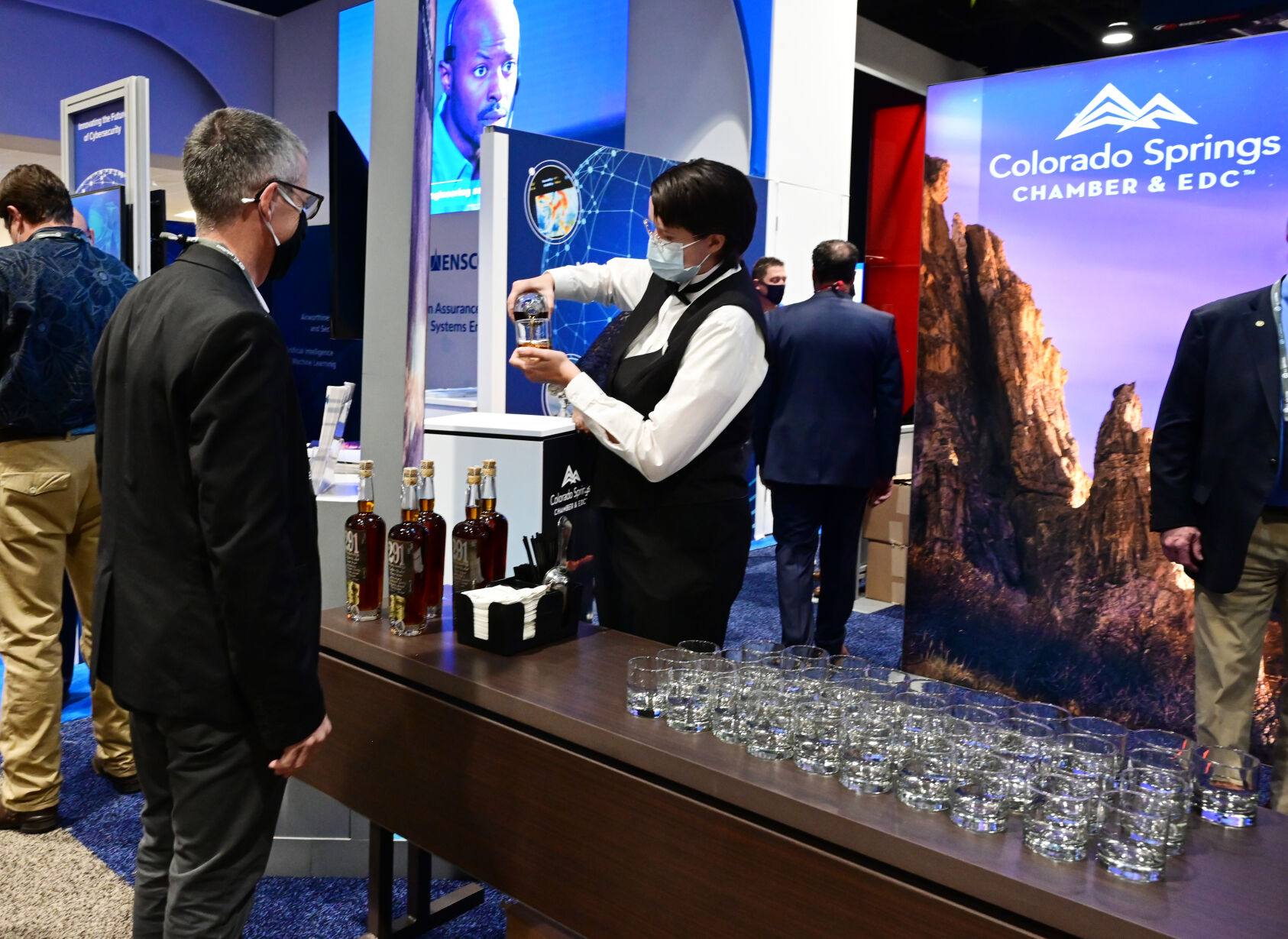 Broadmoor employee Carlisle McCormick pours a Colorado Springs produced bourbon 291 at the Colorado Springs exhibit at the Space Symposium at the Colorado Springs exhibit on Tuesday, Aug. 24, 2021. (Photo by Jerilee Bennett, The Gazette) (JERILEE BENNETT THE GAZETTE)