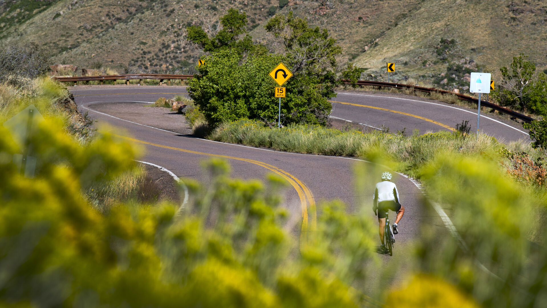Above: A cyclist coasts into a tight turn after climbing the 7,377-foot Lookout Mountain, outside of Golden. (Christian Murdock/The Gazette)