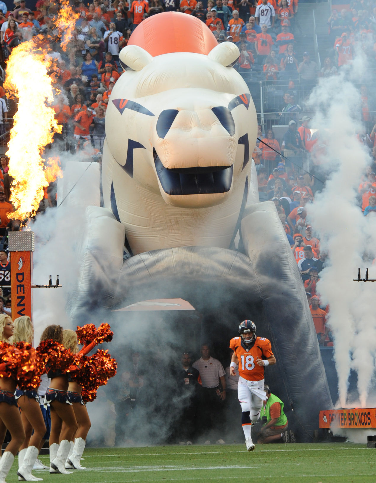 Denver quarterback Peyton Manning runs on the the field as the Broncos are introduced before the start of their preseason game against the Seattle Seahawks Thursday, Aug. 7, 2014, at Sports Authority Field at Mile High in Denver. (The Gazette, Christian Murdock) (CHRISTIAN MURDOCK, THE GAZETTE)