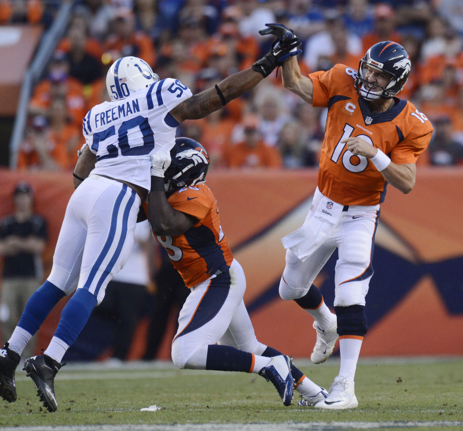 Broncos running back Montee Ball blocks Colts inside linebacker Jerrell Freeman as Peyton Manning throws Sunday, September 7, 2014 at Sports Authority Field at Mile High. Photo by Mark Reis, The Gazette (MARK REIS)