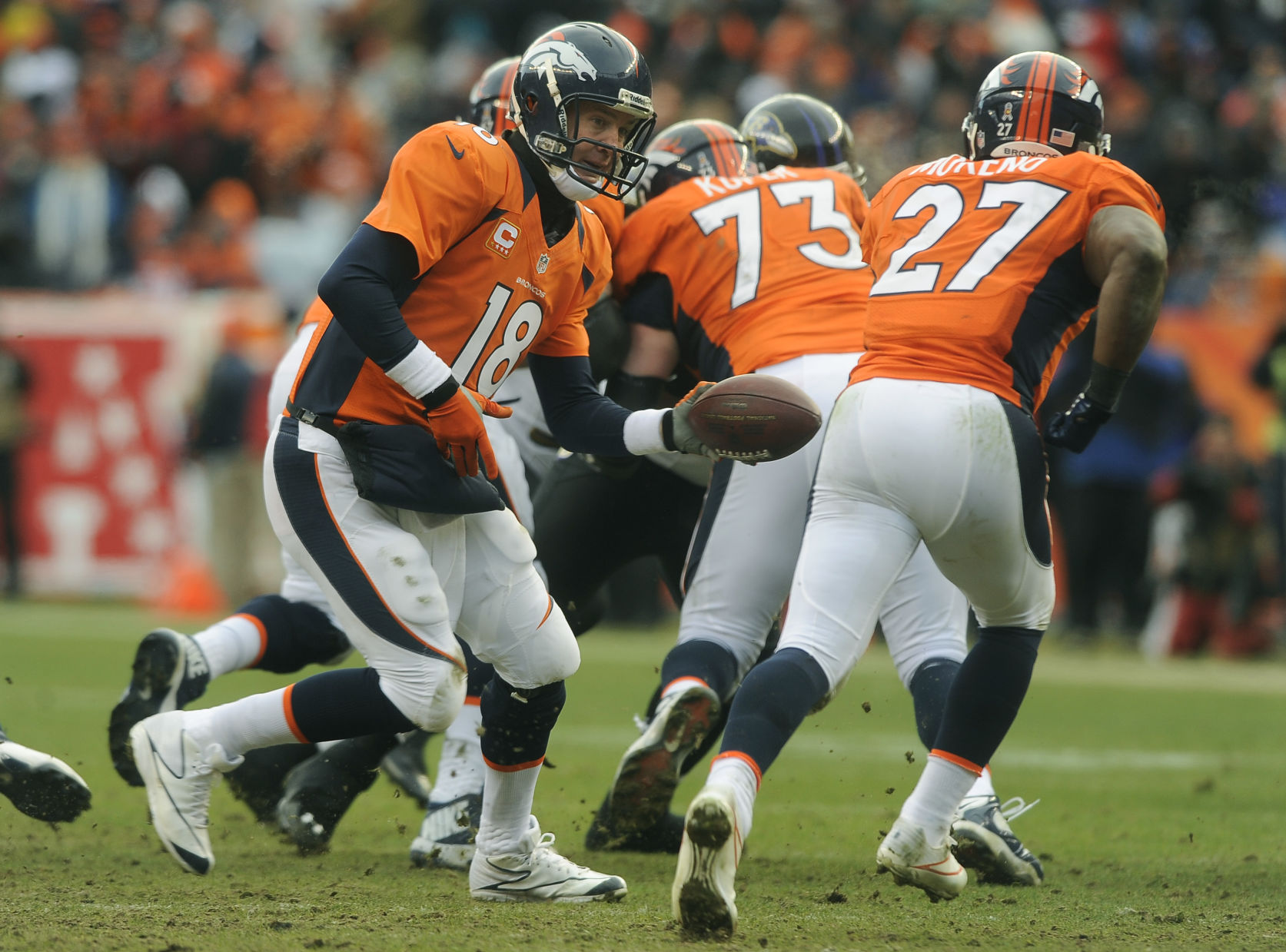 Broncos quarterback Peyton Manning hands off the ball to Broncos running back Knowshon Moreno during the second quarter of a divisional playoff game against the Baltimore Ravens at Mile High Stadium on Saturday, January 12, 2013. (The Gazette/Jerilee Bennett) (Jerilee Bennett)