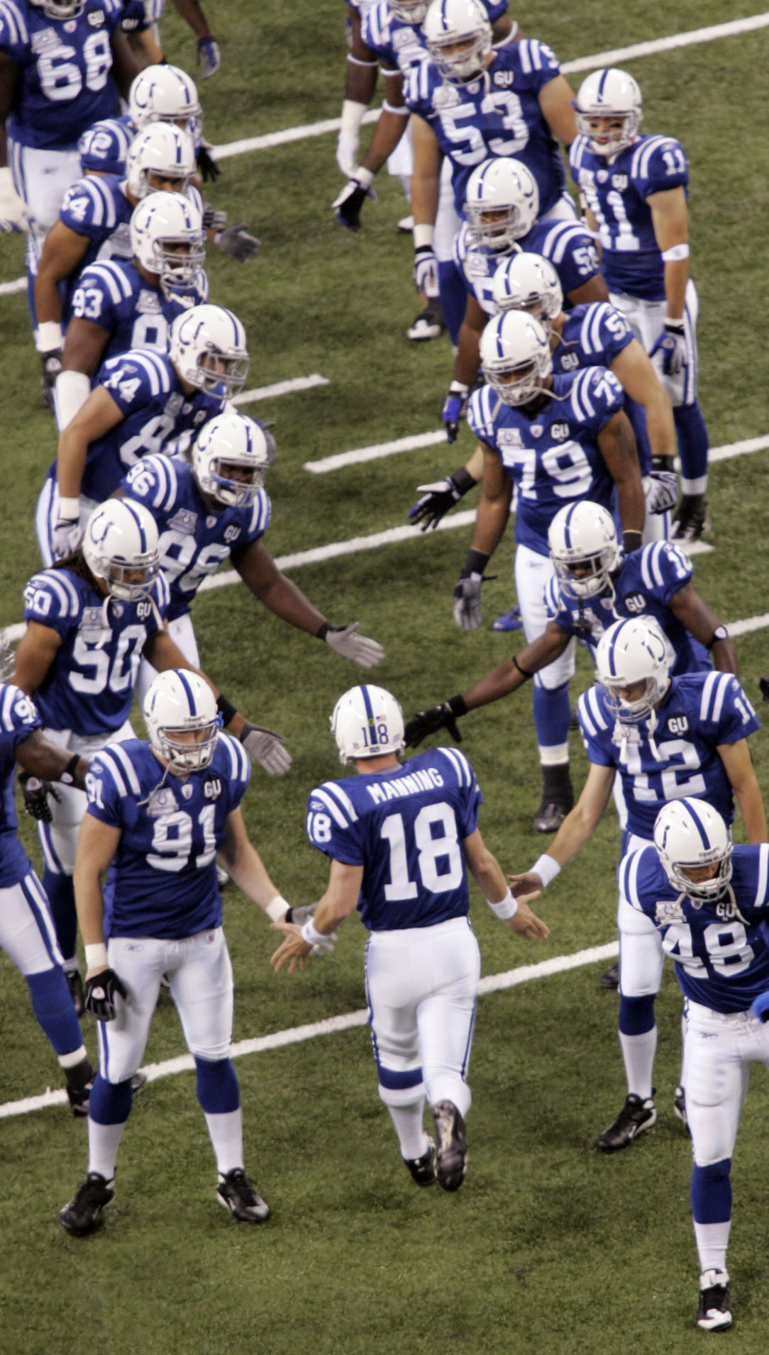 Indianapolis Colts quarterback Peyton Manning (18) gets welcomed to the field by teammates during player introductions before playing the Chicago Bears in an NFL football game on Sunday, Sept. 7, 2008, in Indianapolis. (AP Photo/AJ Mast) (AJ Mast)